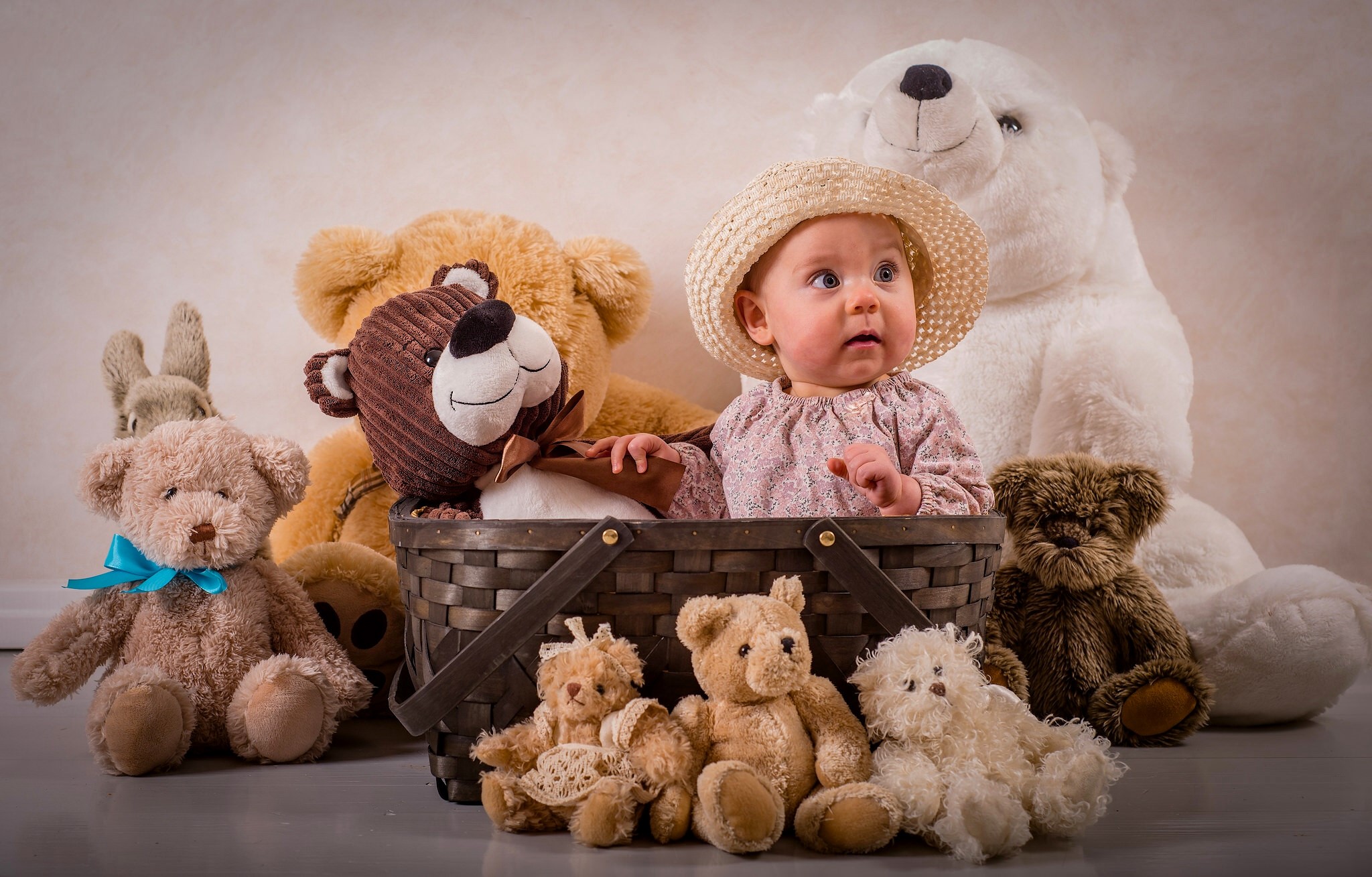 Baby in a hat with teddy bears in a basket HD Wallpaper