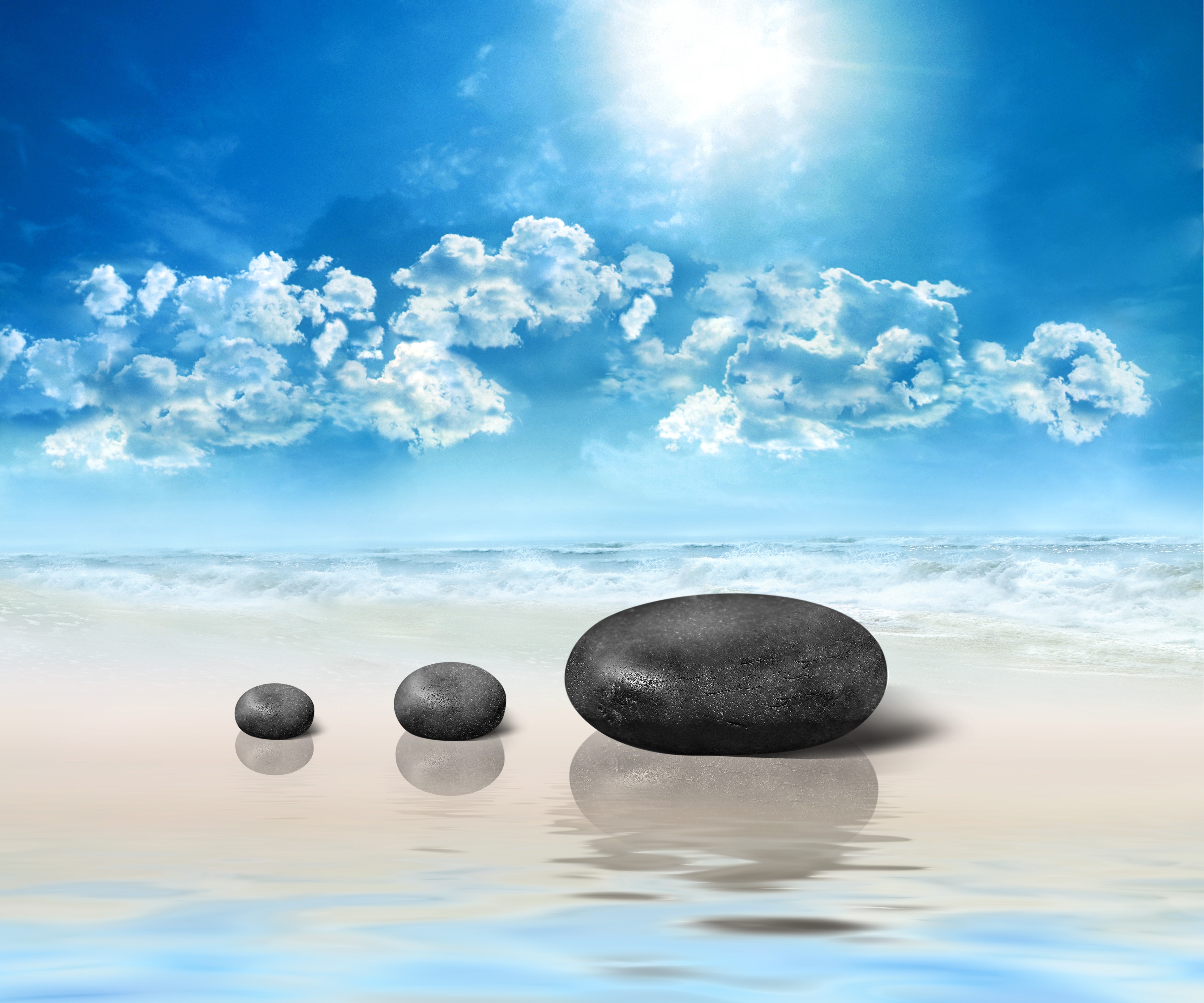 Stones on a beach with ocean and sky HD Wallpaper