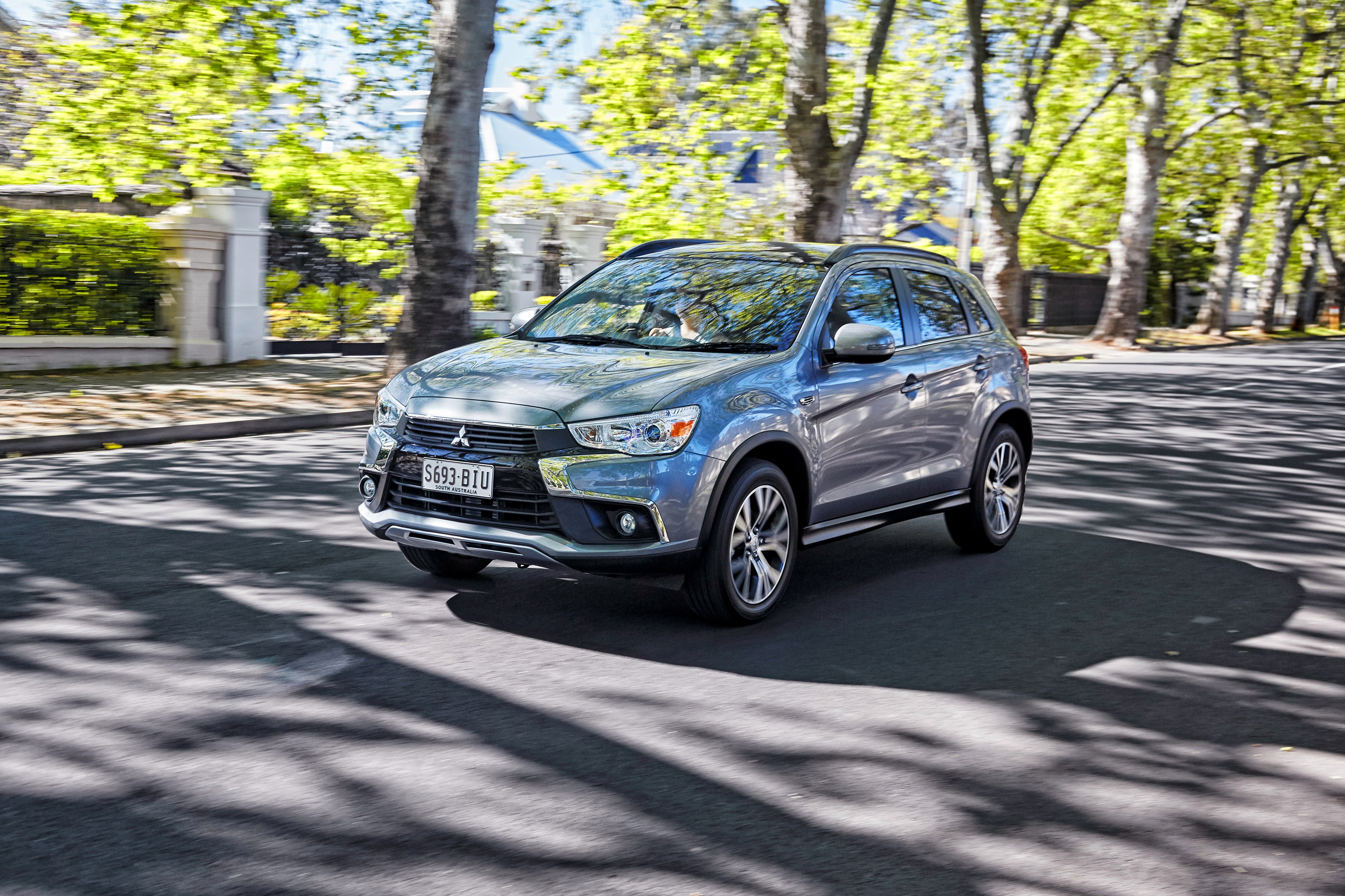 2016 Mitsubishi ASX driving on a tree-lined street HD Wallpaper