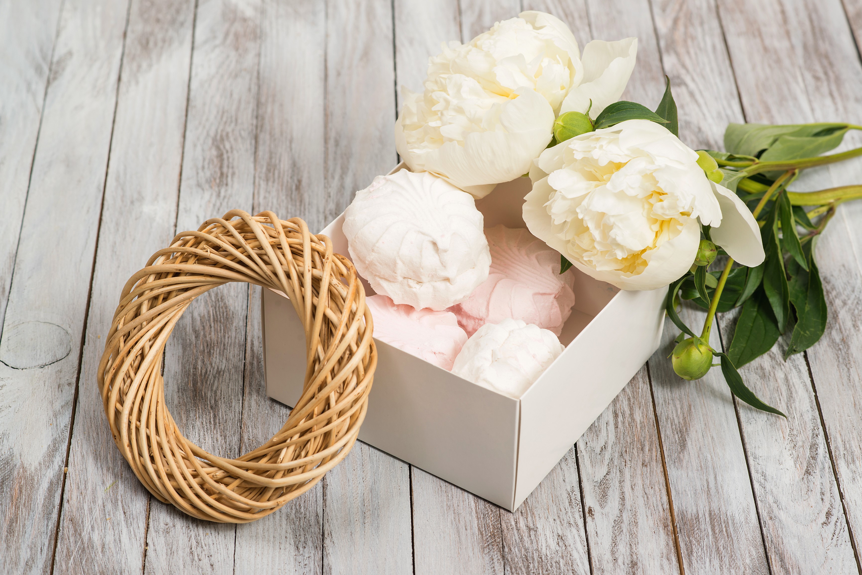 White peonies and sweets in a box on wood planks HD Wallpaper