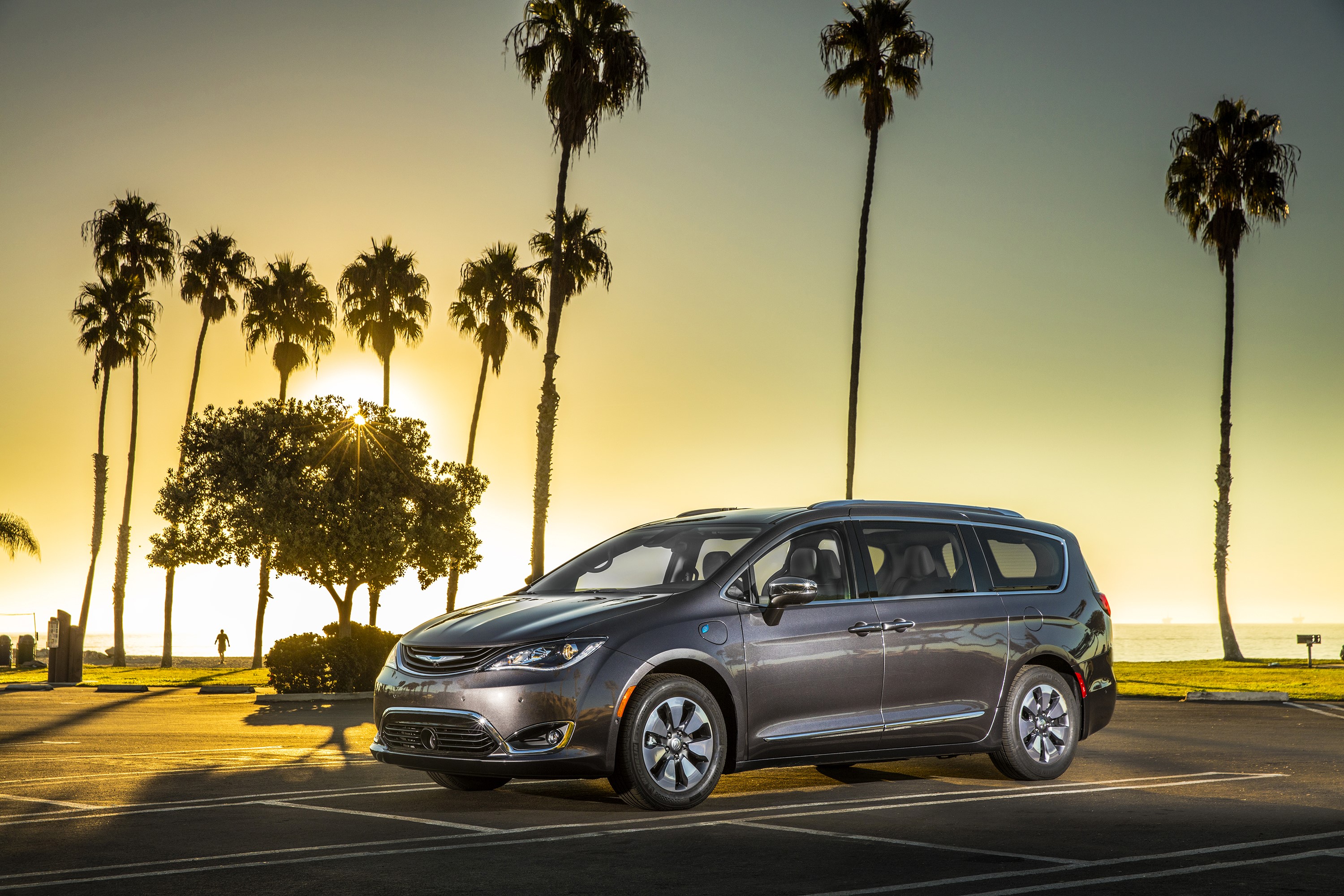 2017 Chrysler Pacifica Hybrid parked by palm trees at sunset HD Wallpaper