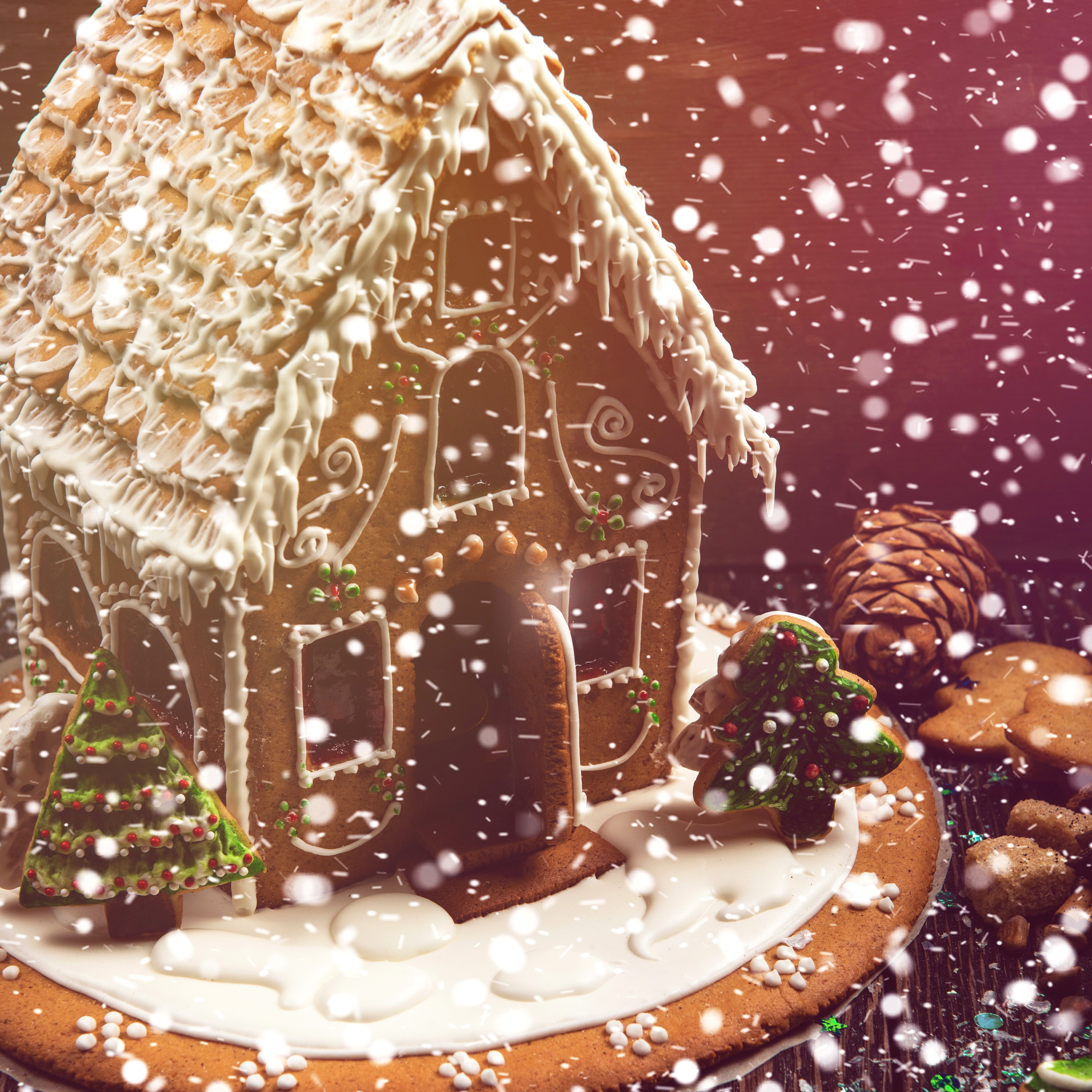 Gingerbread house with Christmas decorations and falling snow HD Wallpaper