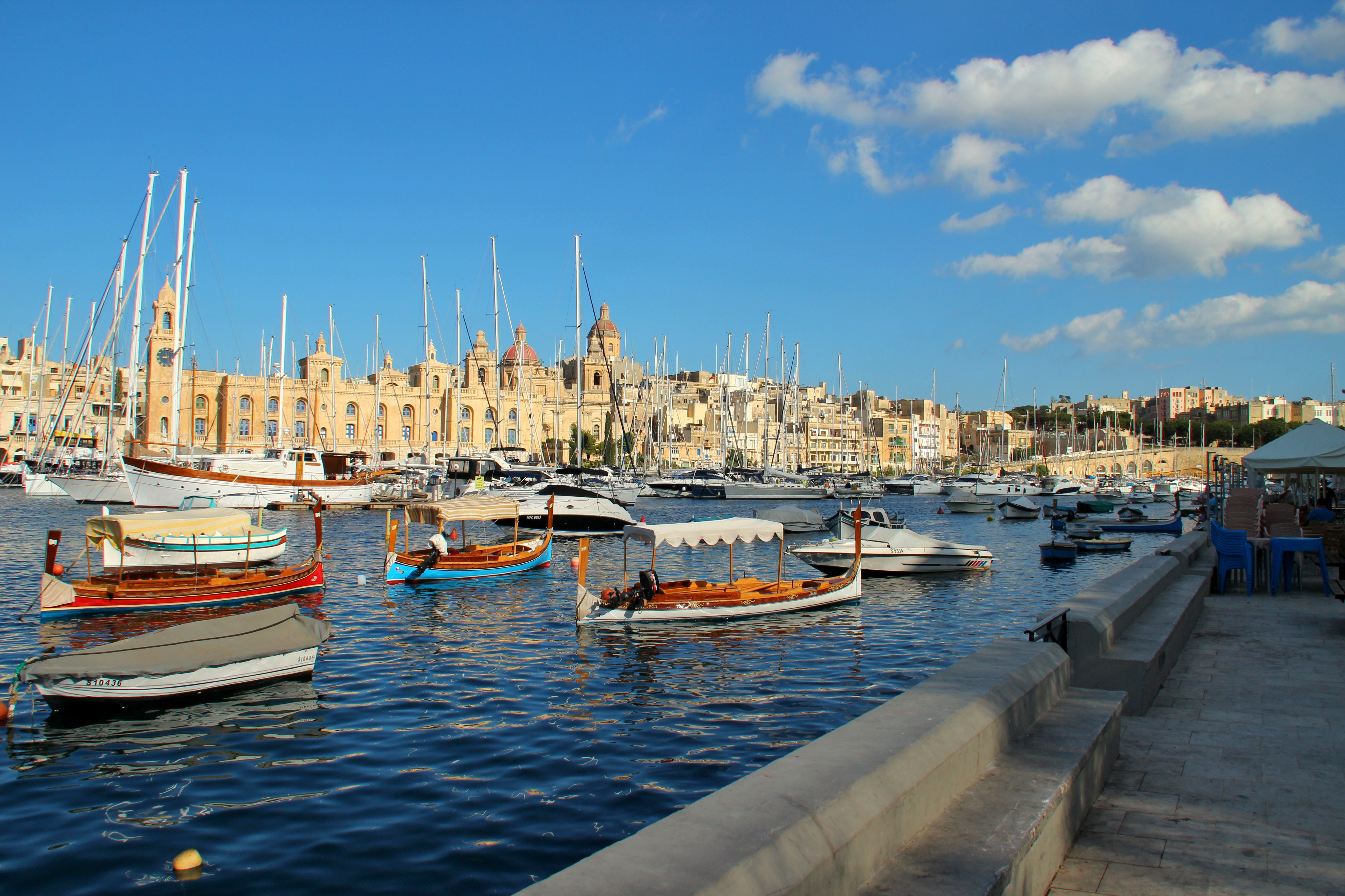 Boats in a harbor with buildings and sailboats in Malta HD Wallpaper