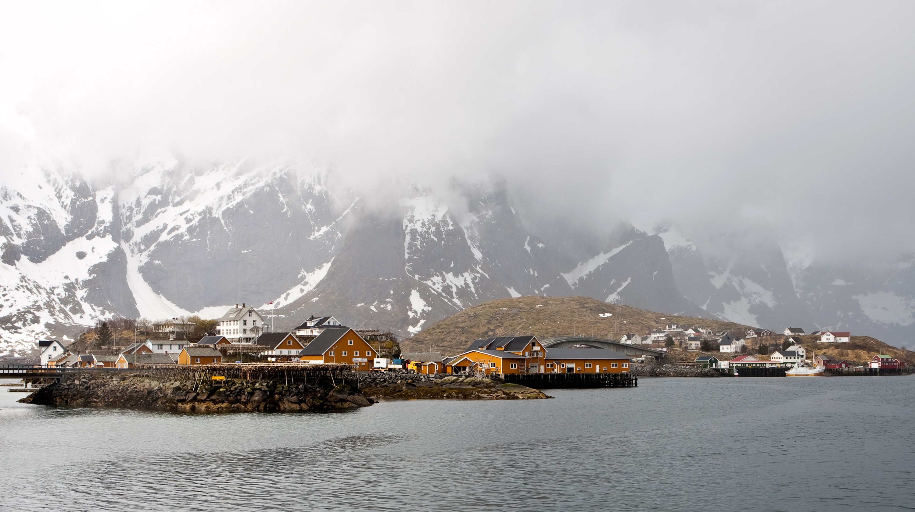 Norwegian village with snow-capped mountains and a lake HD Wallpaper