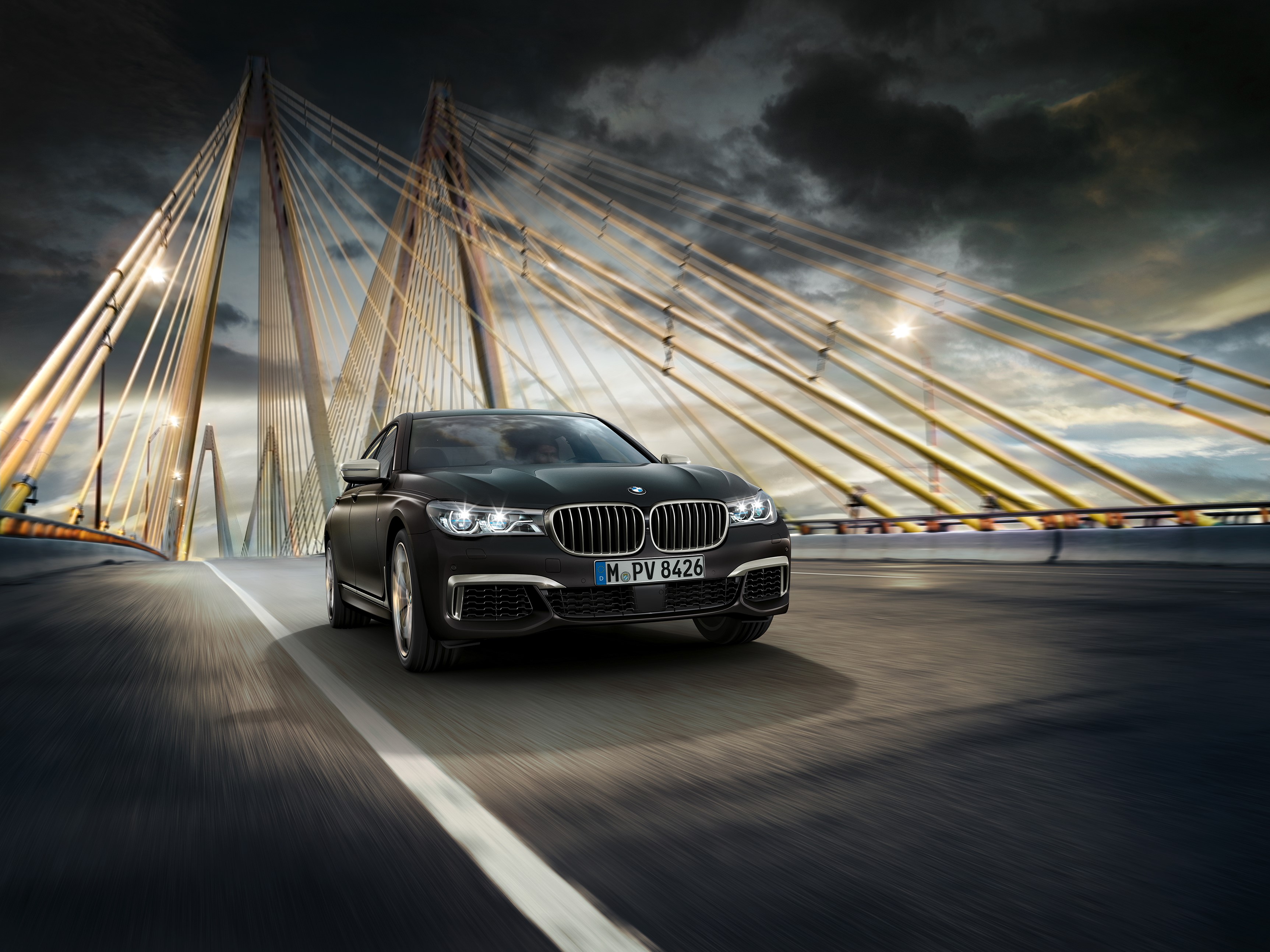 BMW M760Li xDrive driving on a bridge HD Wallpaper