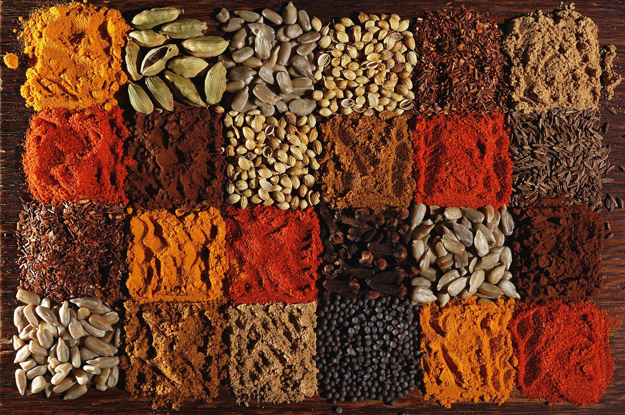 Assortment of spices and seeds arranged in squares HD Wallpaper