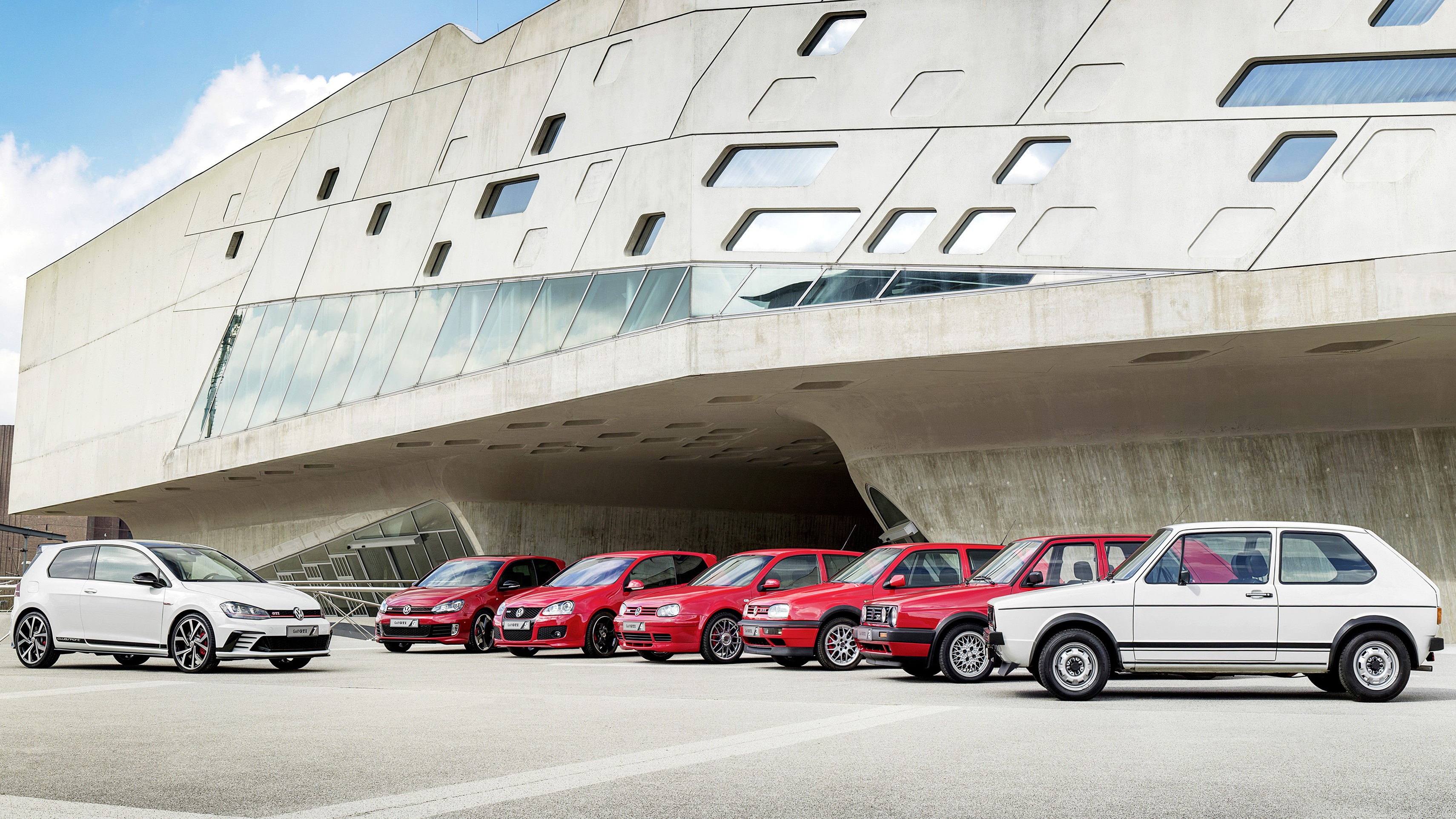 Volkswagen Golf Generations Lined Up Outside Modern Building HD Wallpaper