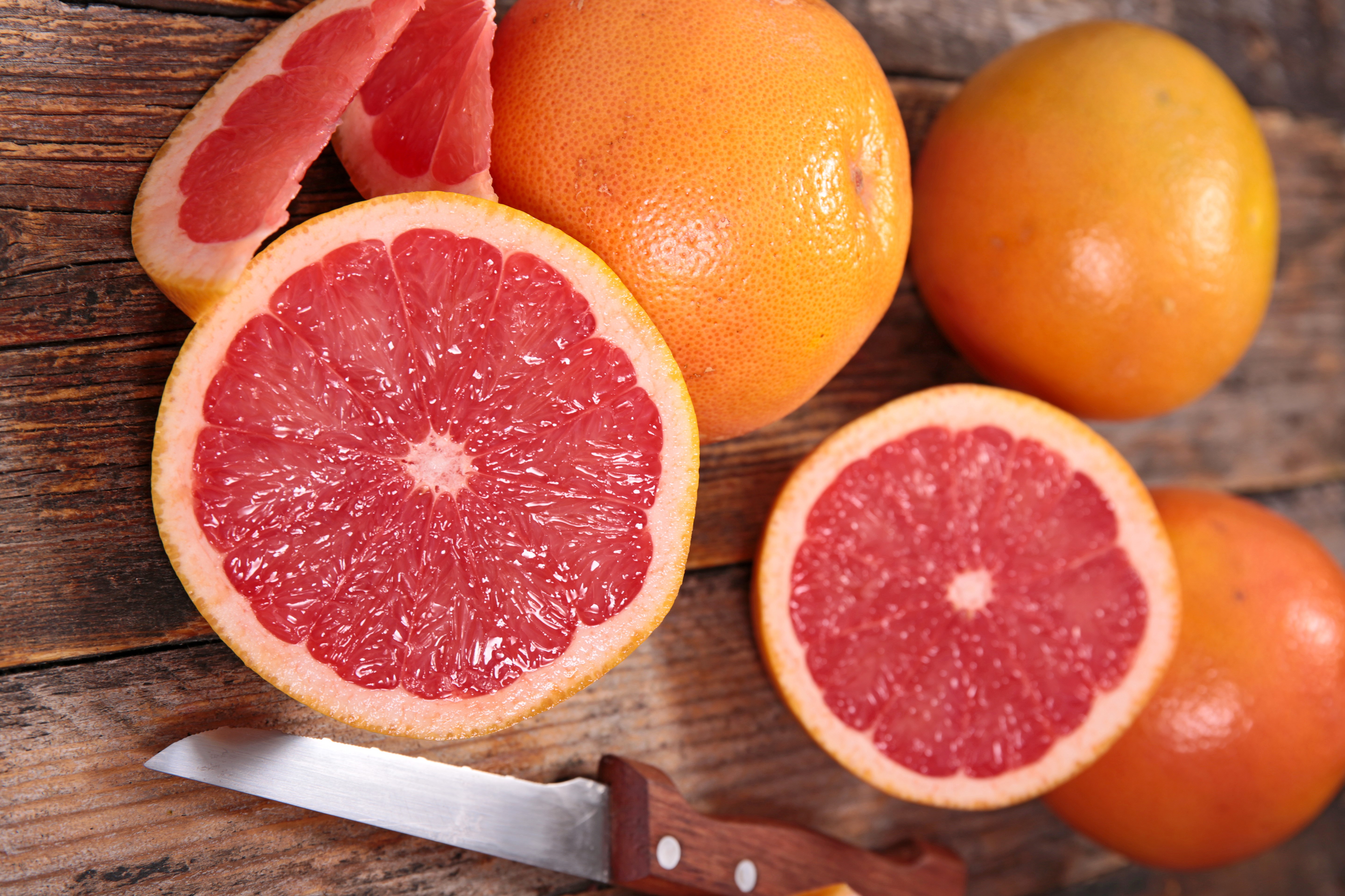 Grapefruits on a wooden table HD Wallpaper