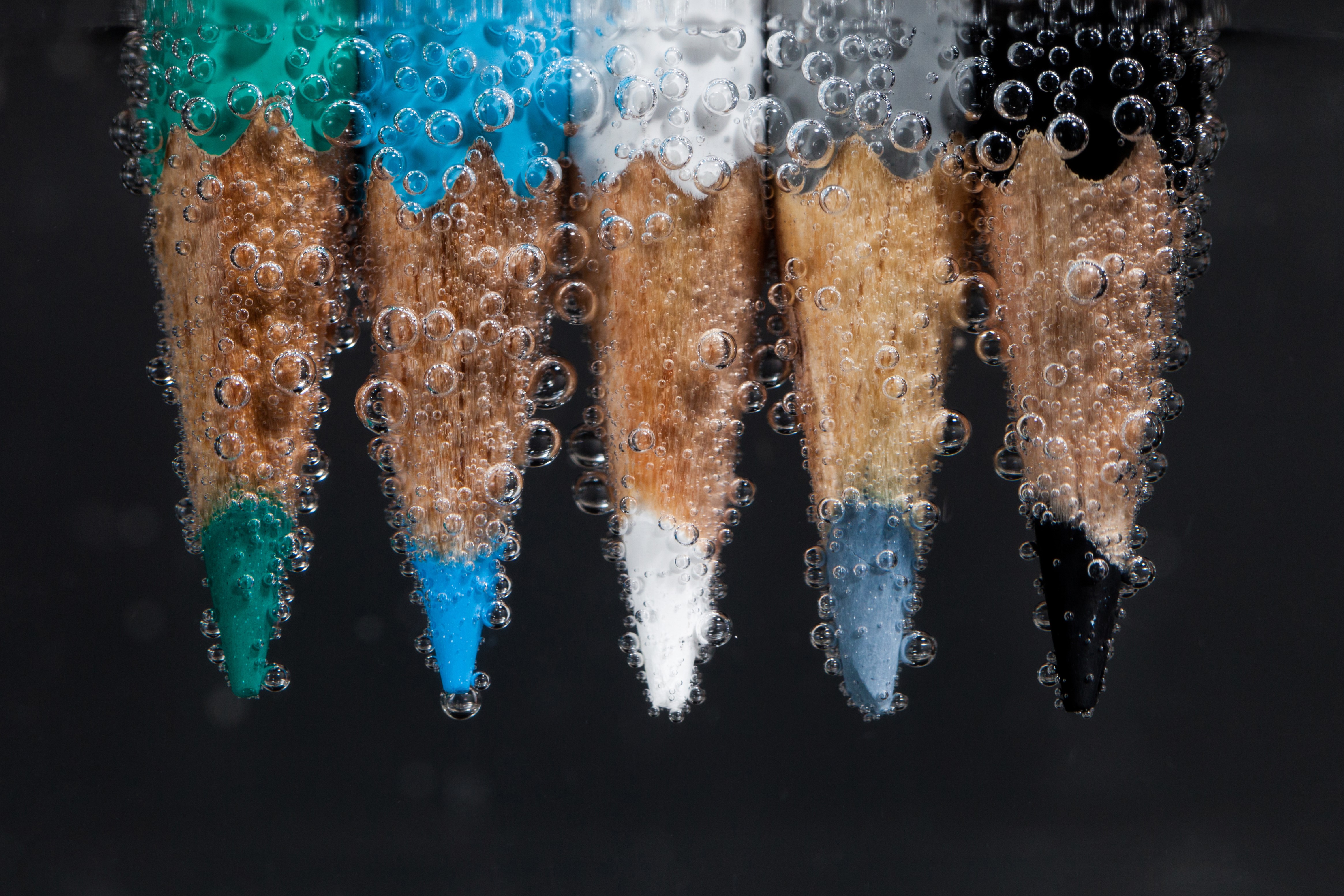 Colored pencils underwater with bubbles HD Wallpaper