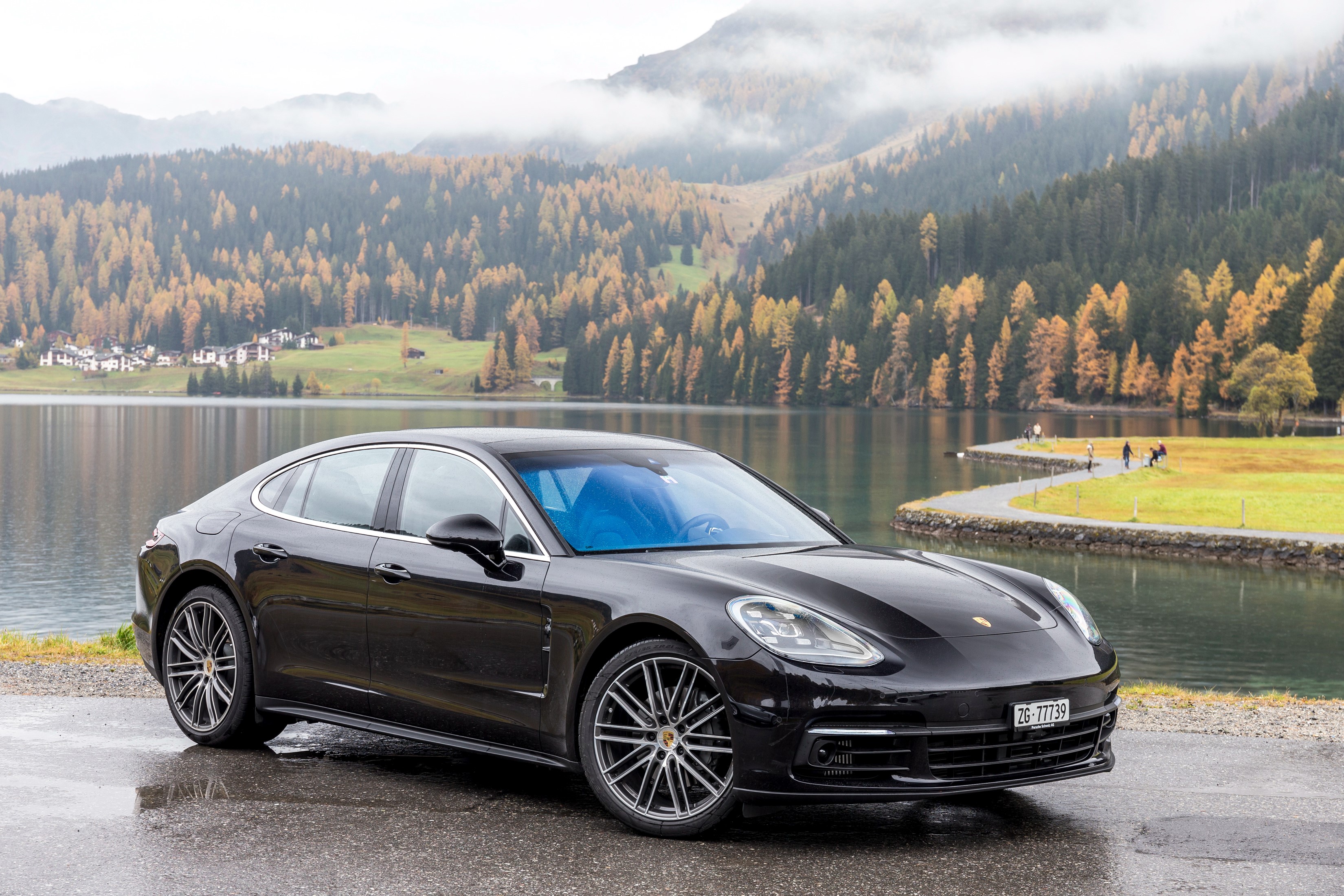 Black Porsche Panamera 4S parked by a lake in autumn HD Wallpaper