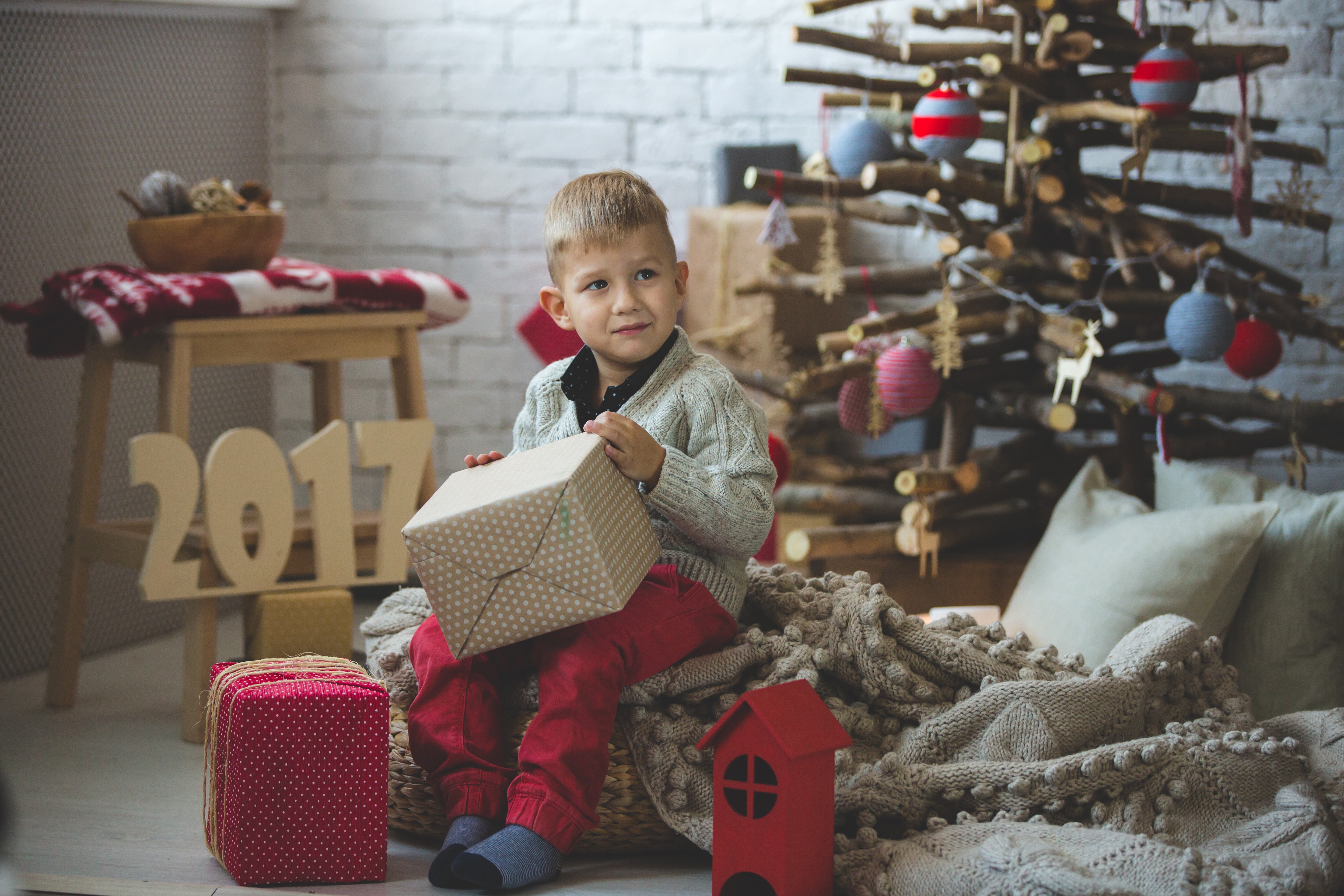 Boy with Gifts near Christmas Tree and 2017 Sign HD Wallpaper
