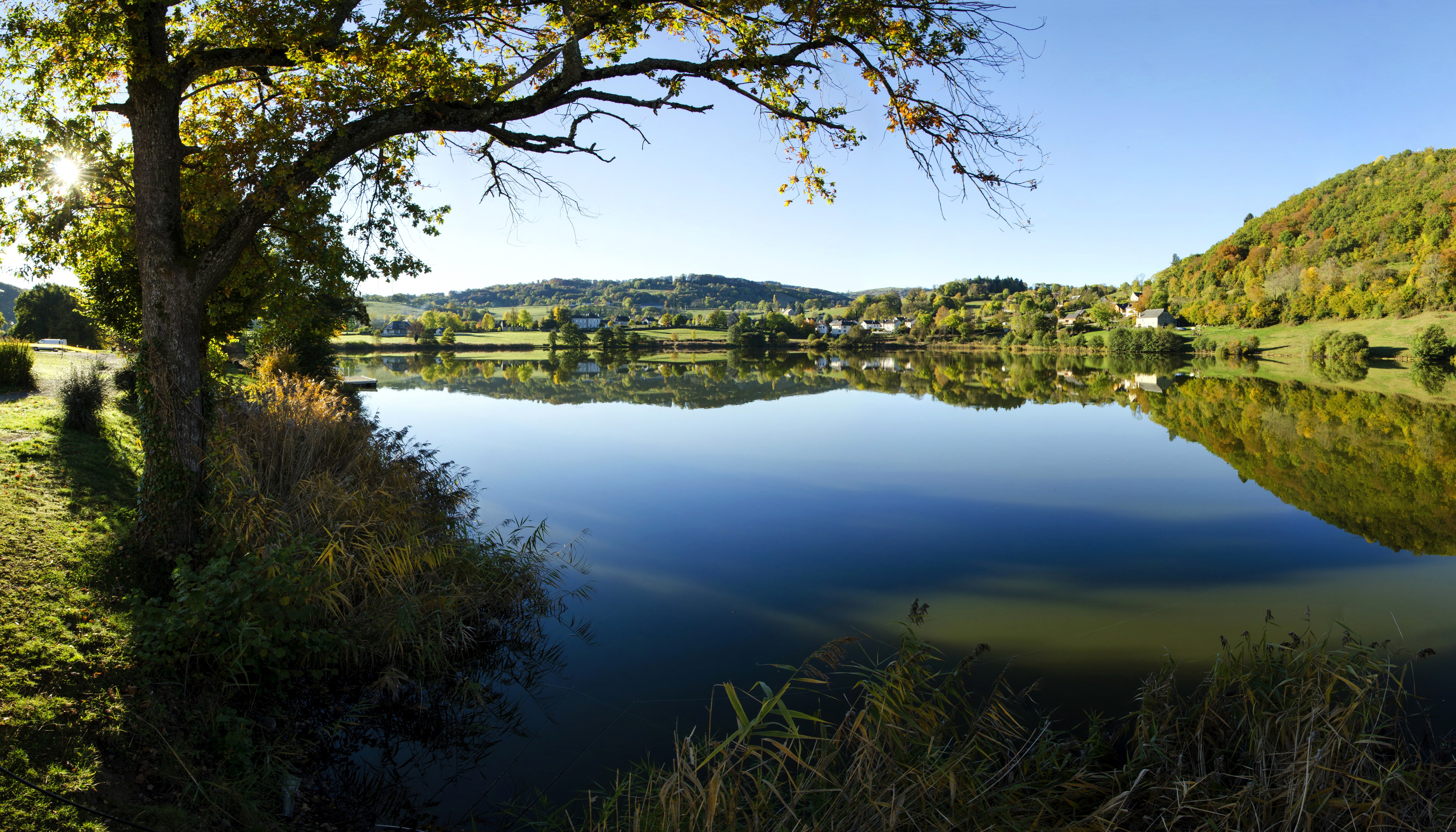 Lake with tree and village in France HD Wallpaper