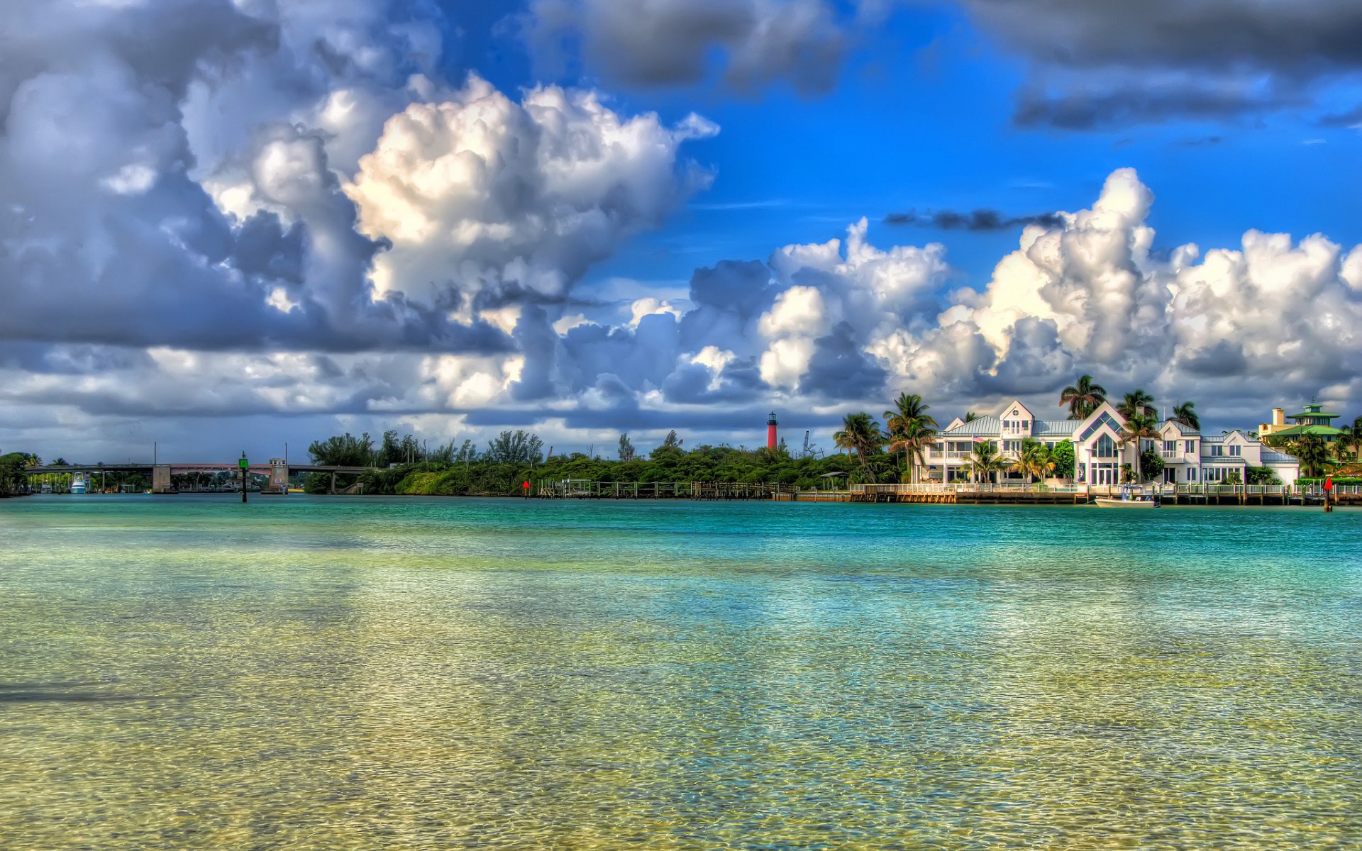 Waterfront houses and lighthouse with a bridge HD Wallpaper