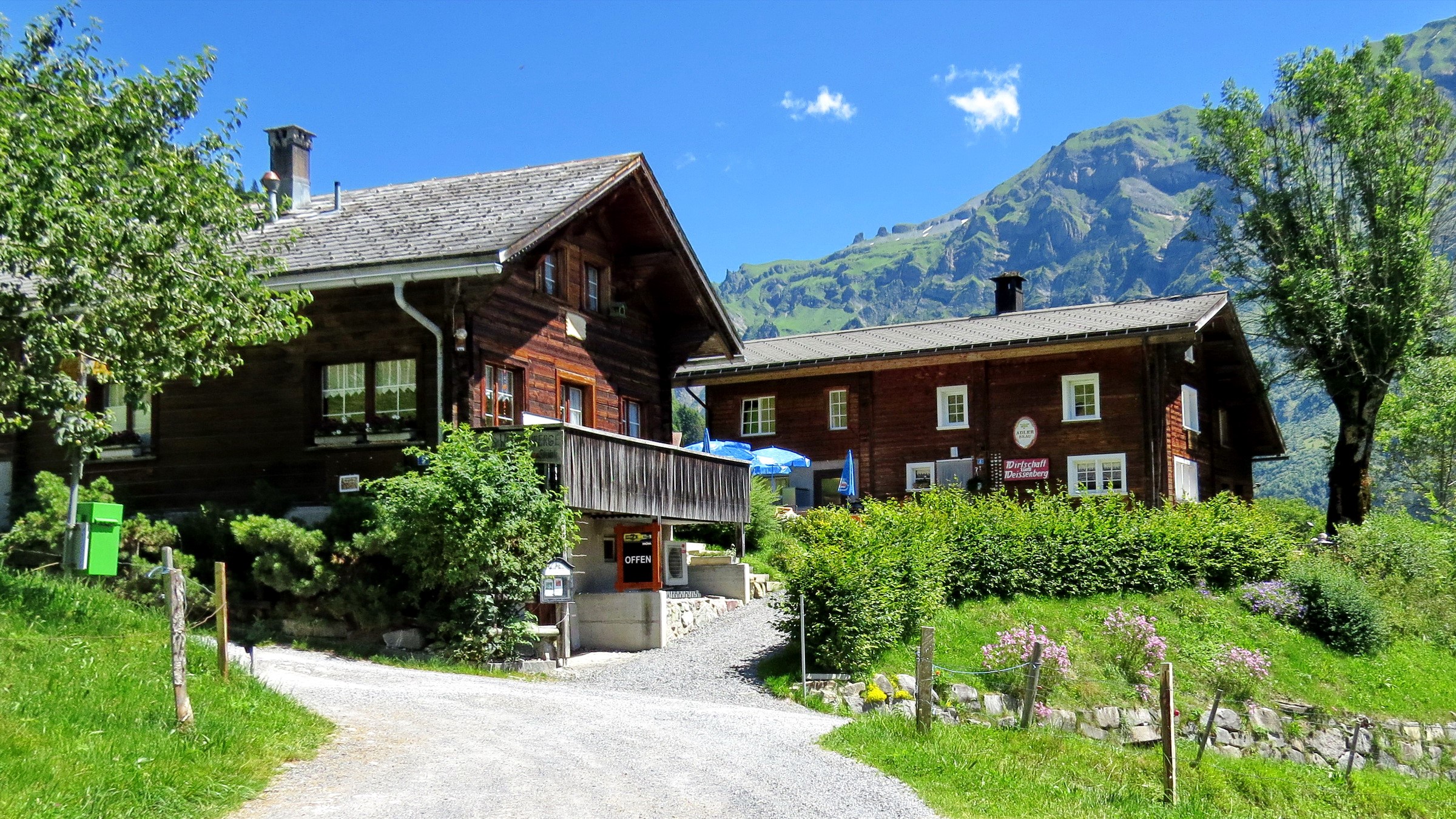 Wooden houses in Weissenberge, Switzerland with mountains HD Wallpaper