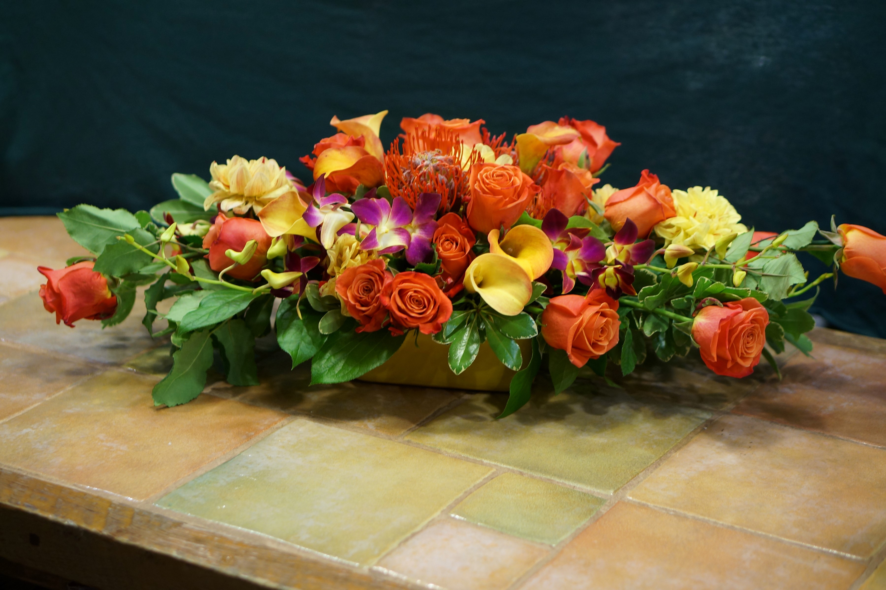 Orange roses, calla lilies, and orchids floral arrangement HD Wallpaper