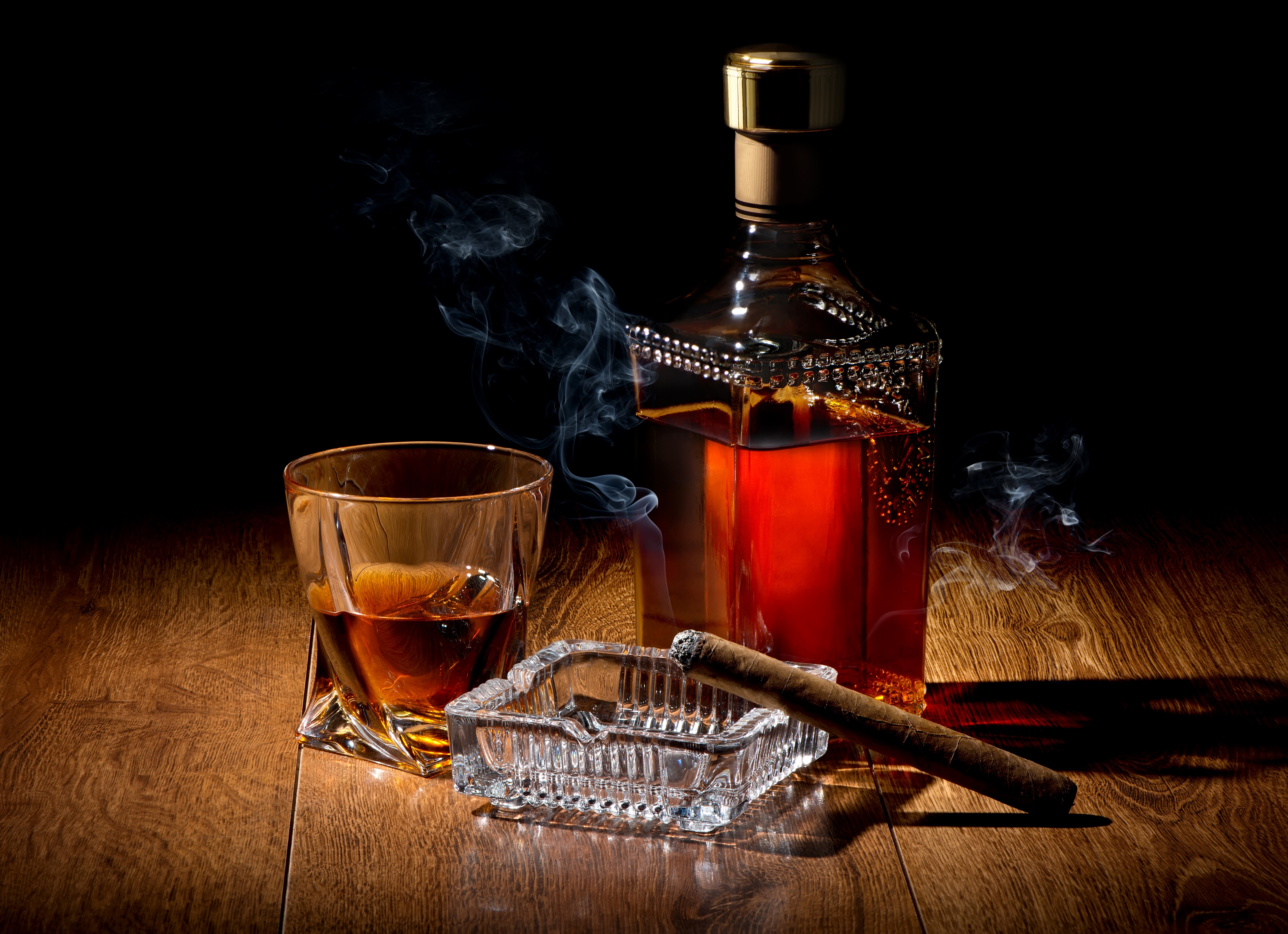Whisky bottle, glass, ashtray, and cigar with smoke HD Wallpaper