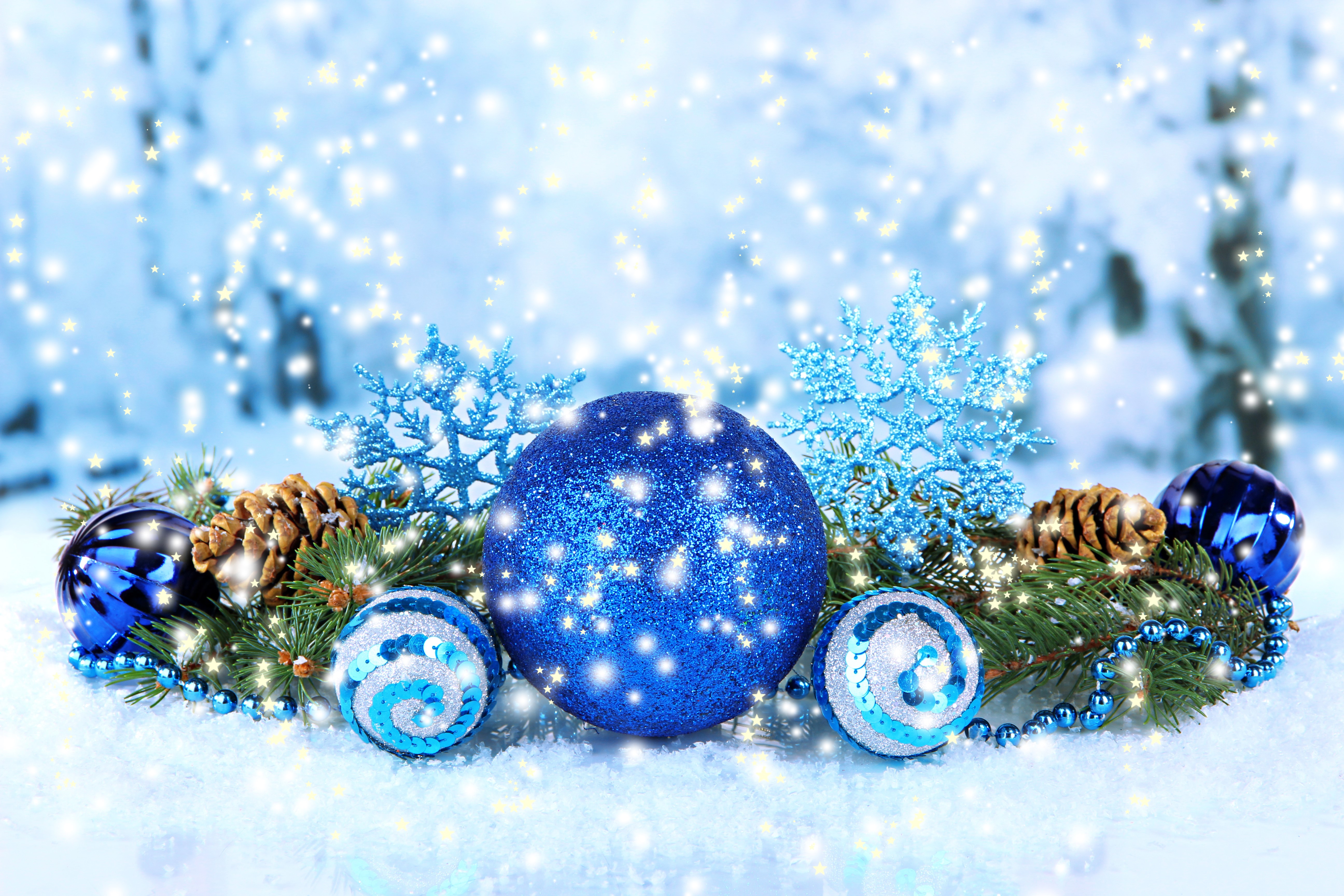 Christmas ornaments and pine cones on snowy branches HD Wallpaper