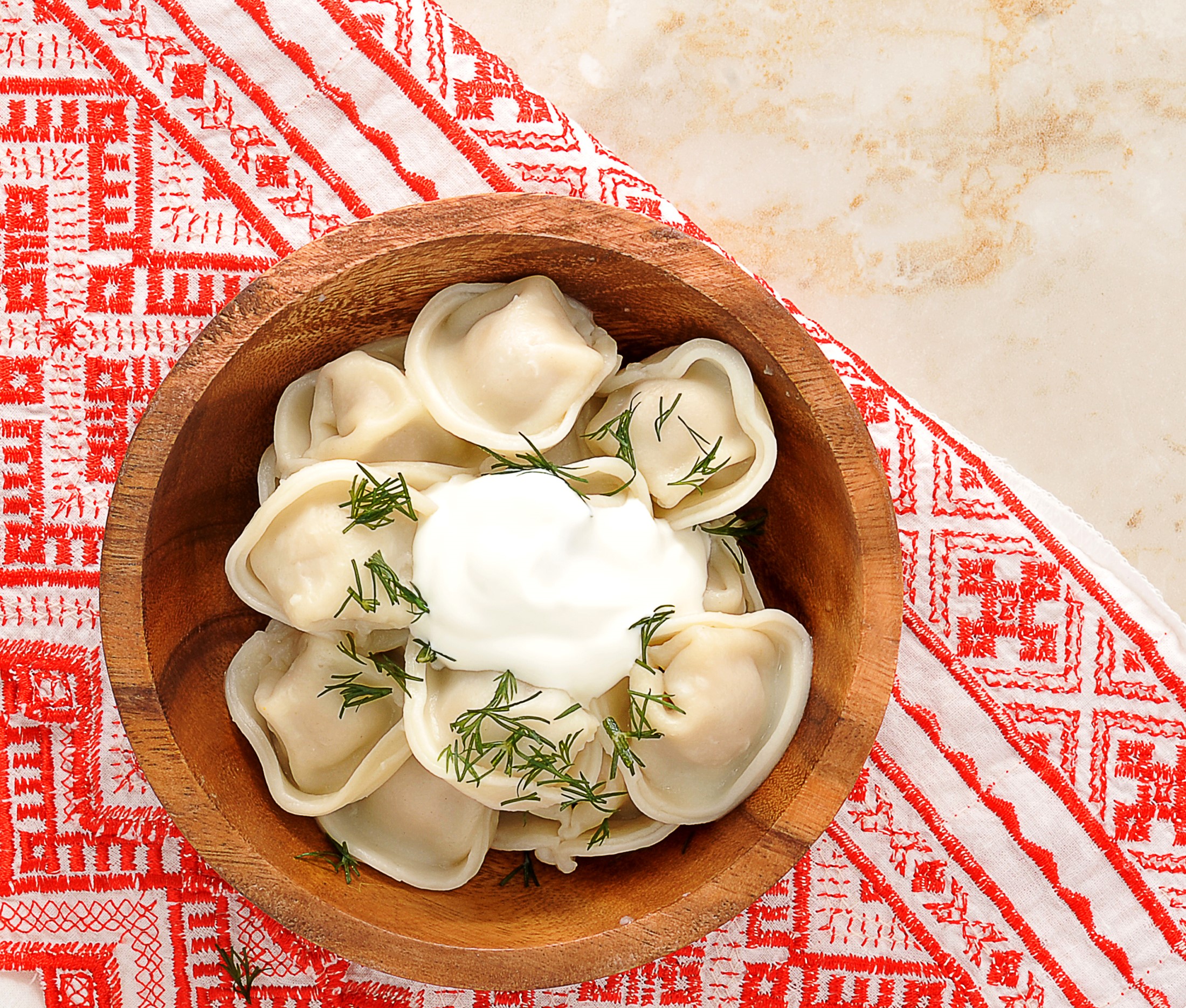 Pelmeni with sour cream and dill in a wooden bowl HD Wallpaper