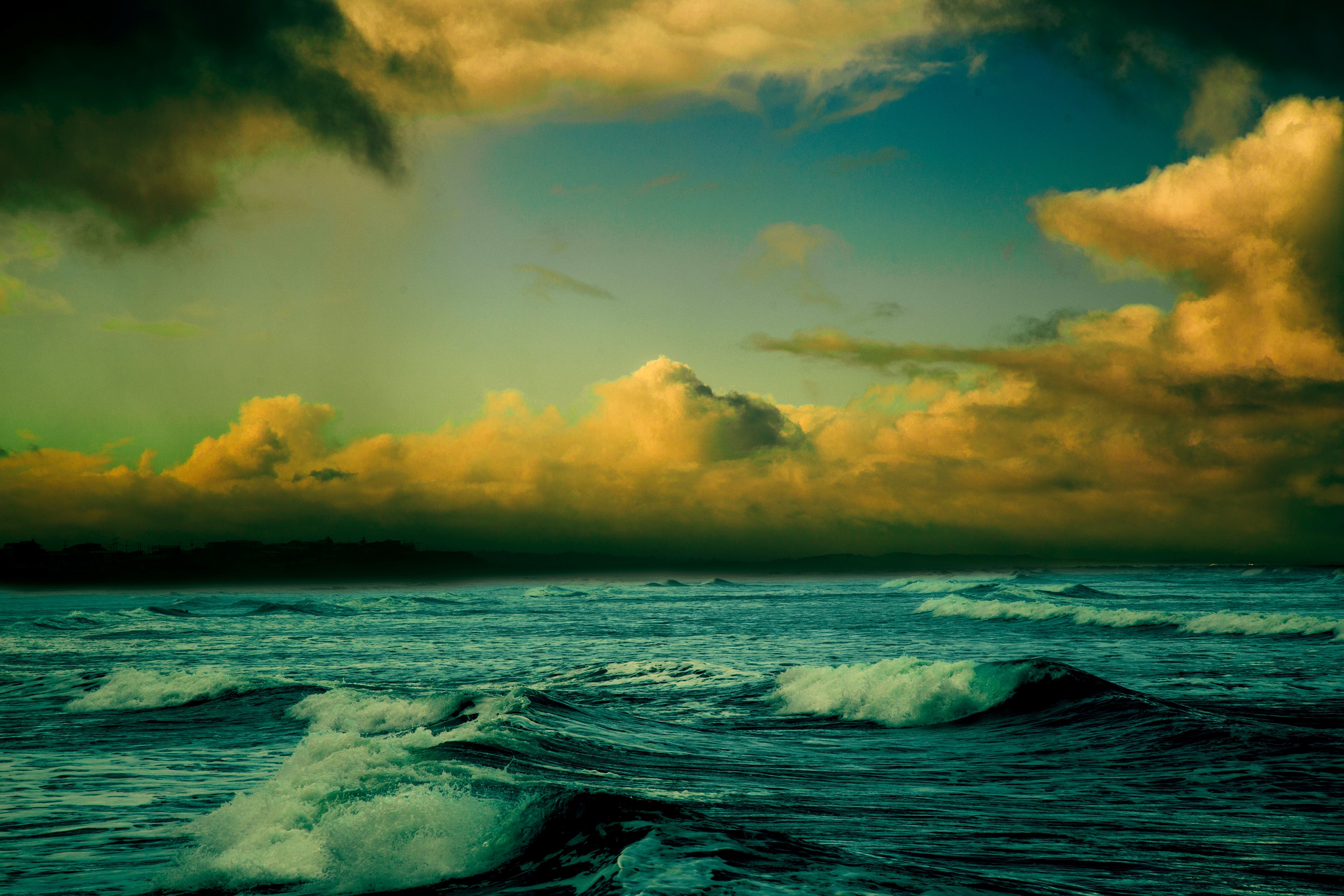 Ocean waves under dramatic clouds HD Wallpaper