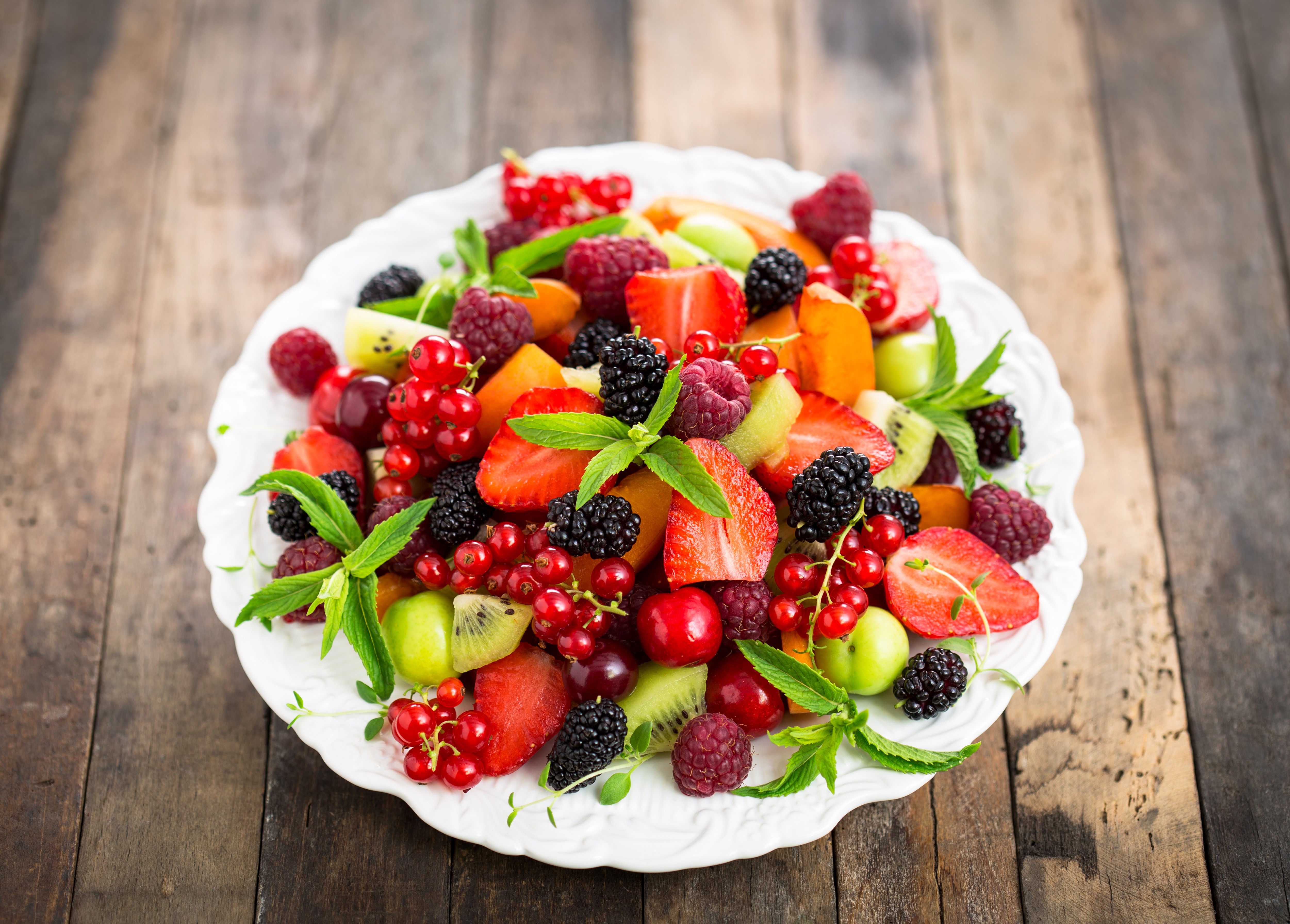 Fruit Salad on a White Plate with Wood Background HD Wallpaper