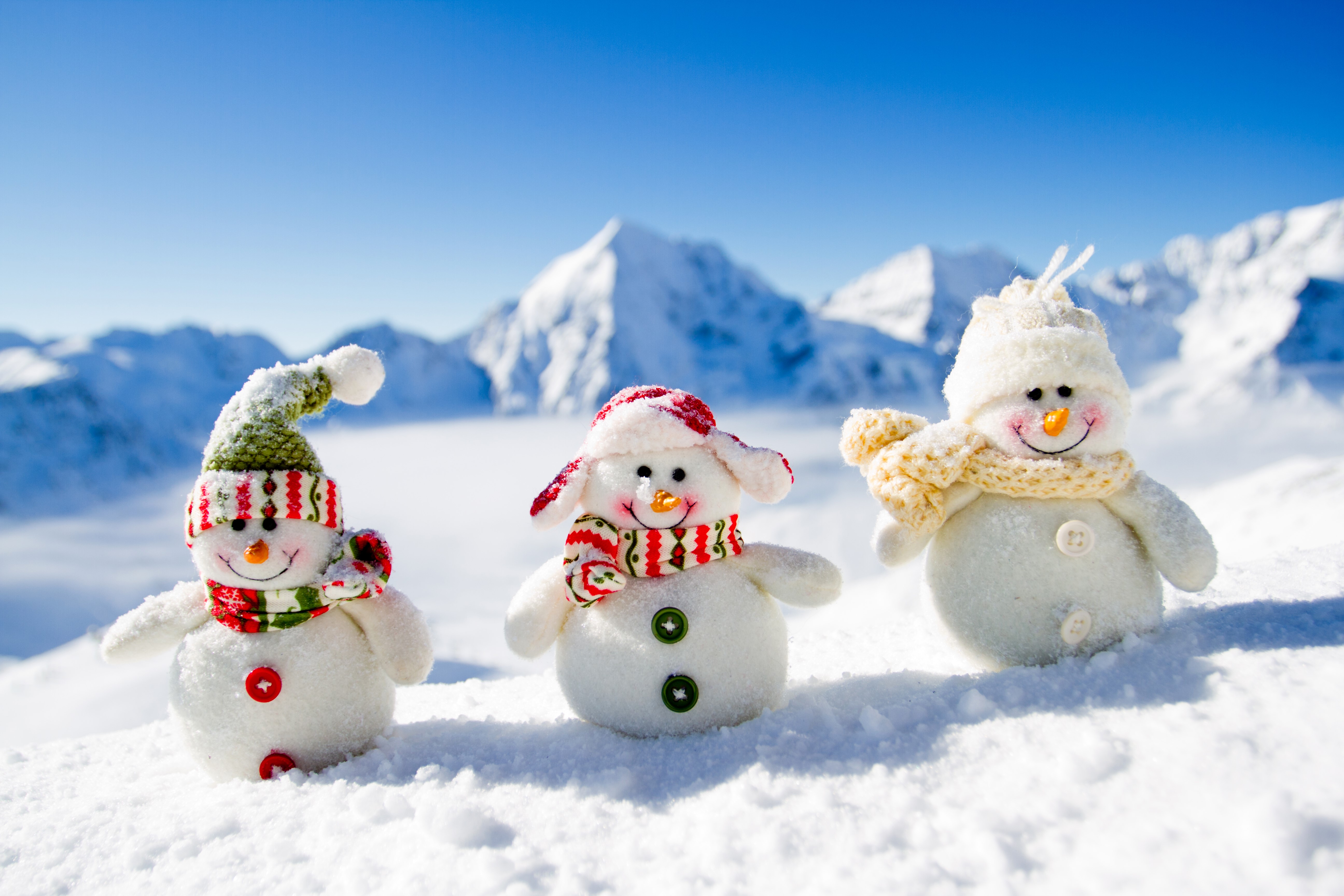 Three snowmen in a snowy mountain landscape HD Wallpaper