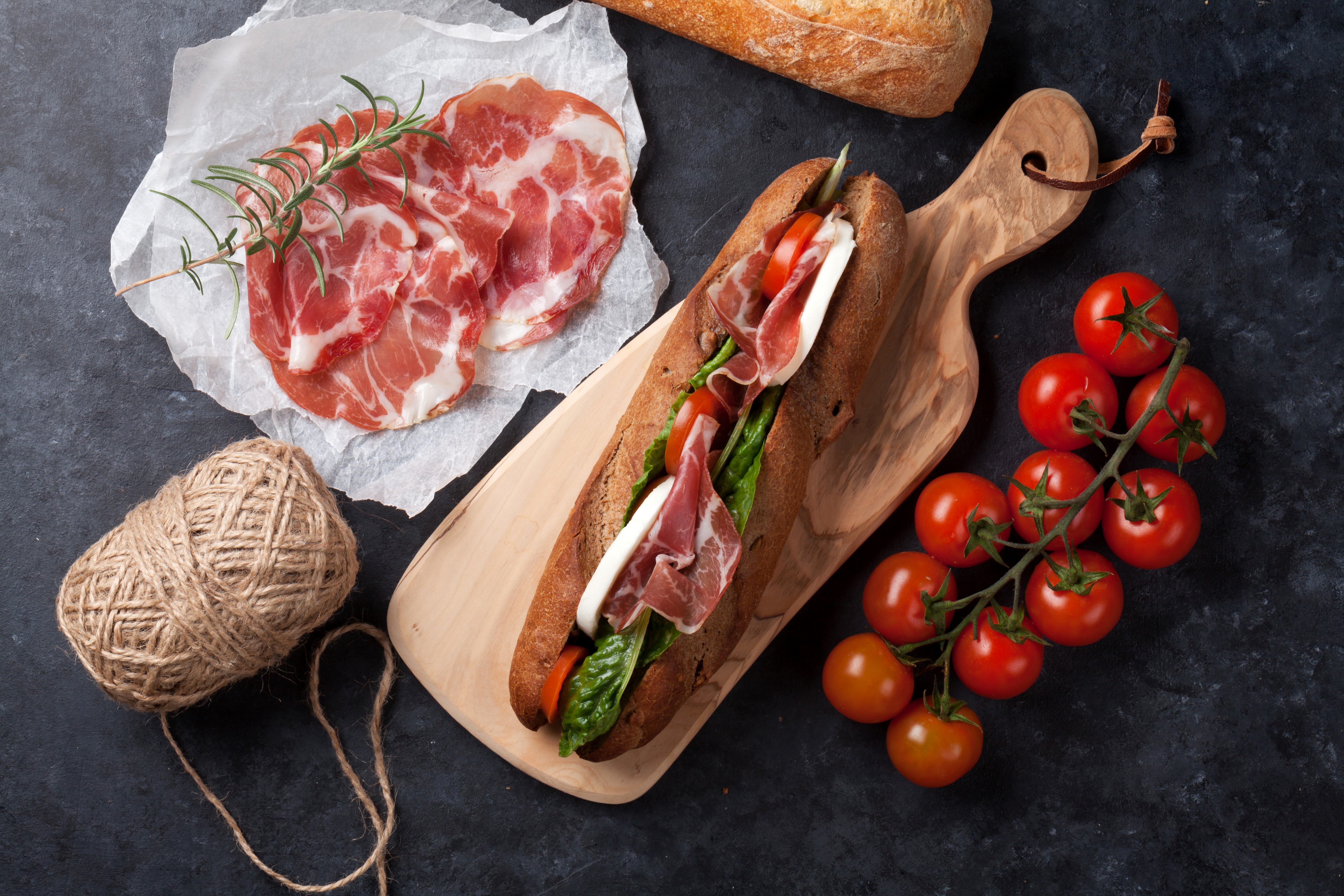 Sandwich with ham, tomatoes, and mozzarella on a cutting board HD Wallpaper