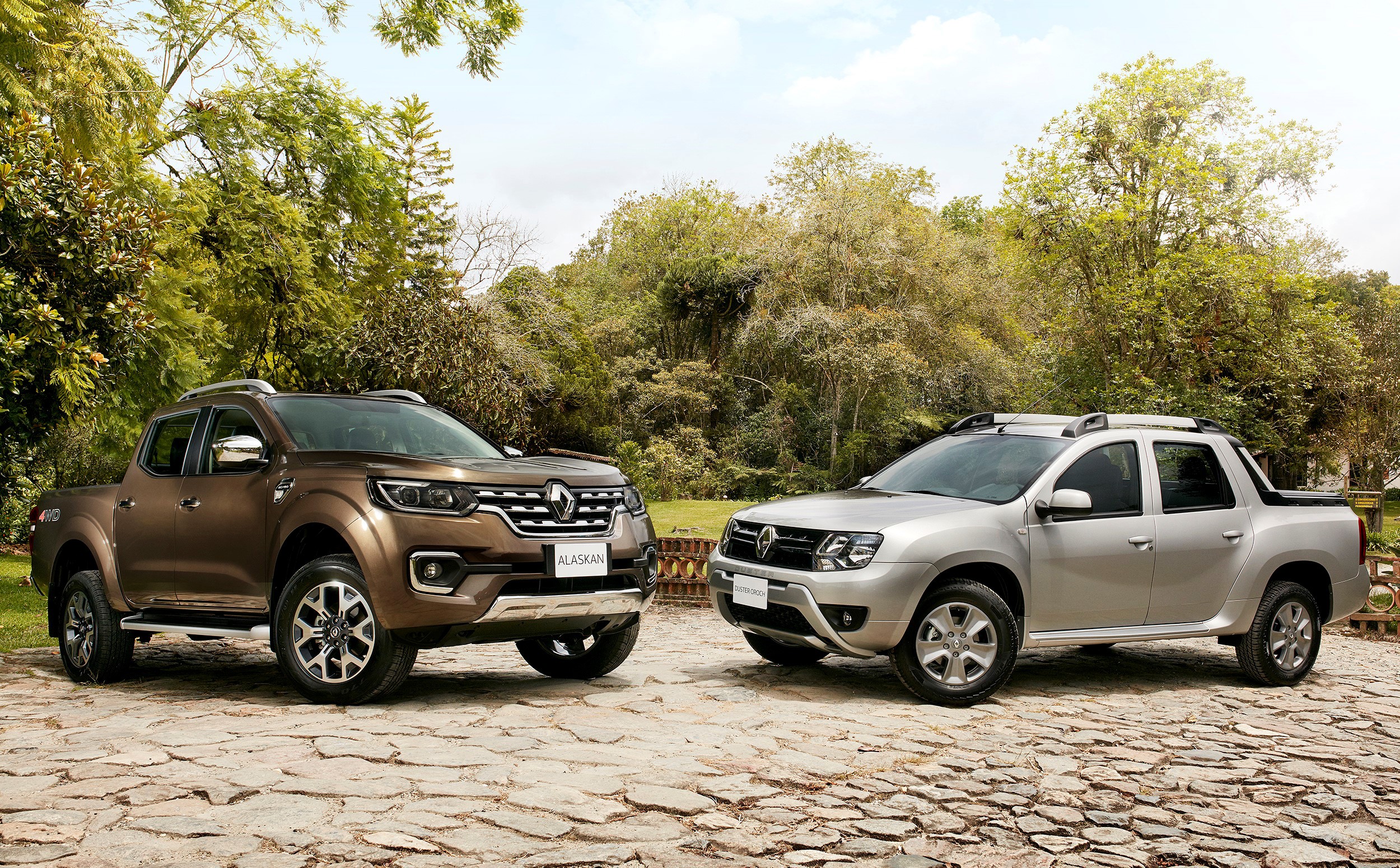 Two Renault Alaskan pickup trucks parked outdoors HD Wallpaper