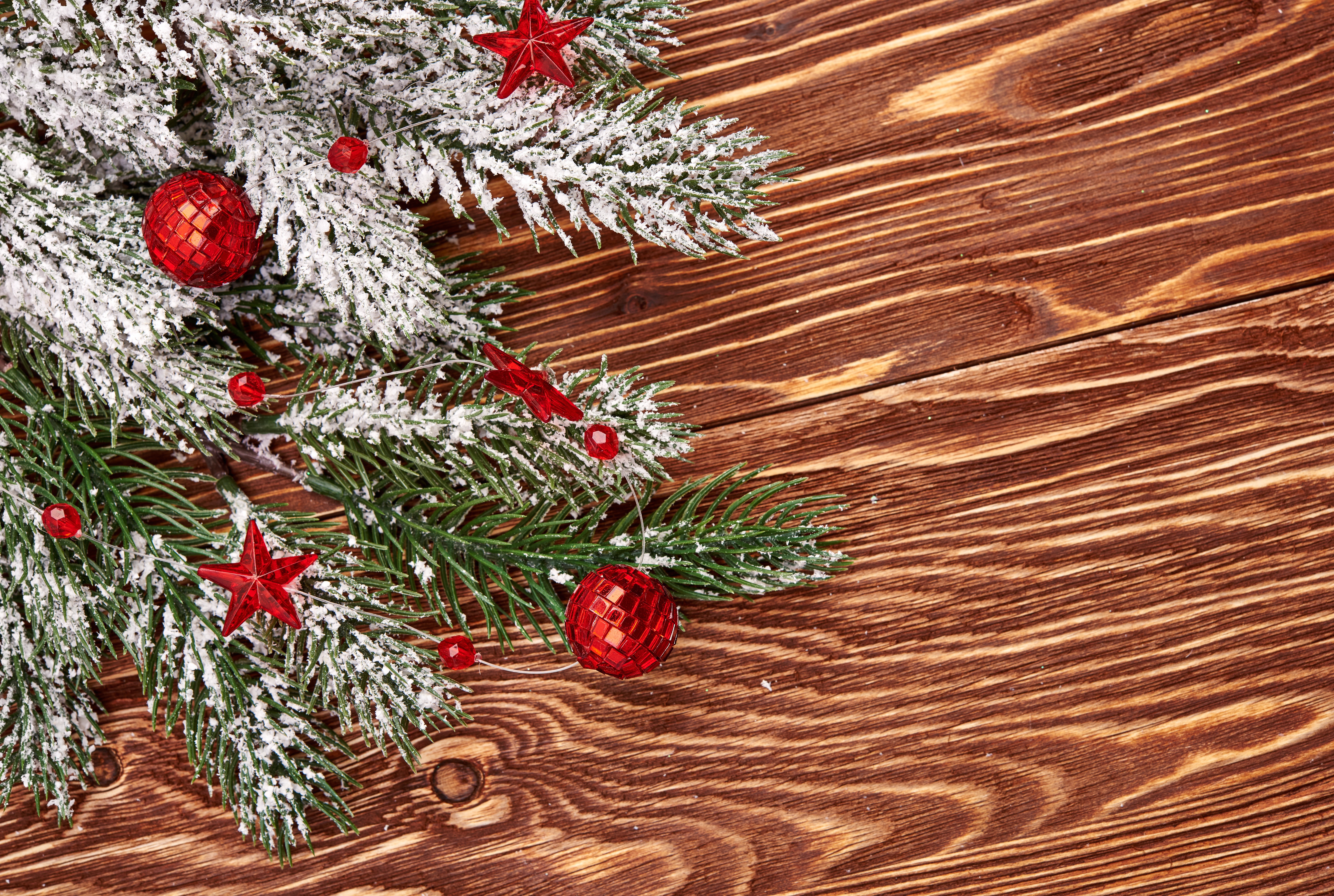 Christmas branches with red ornaments on wood HD Wallpaper
