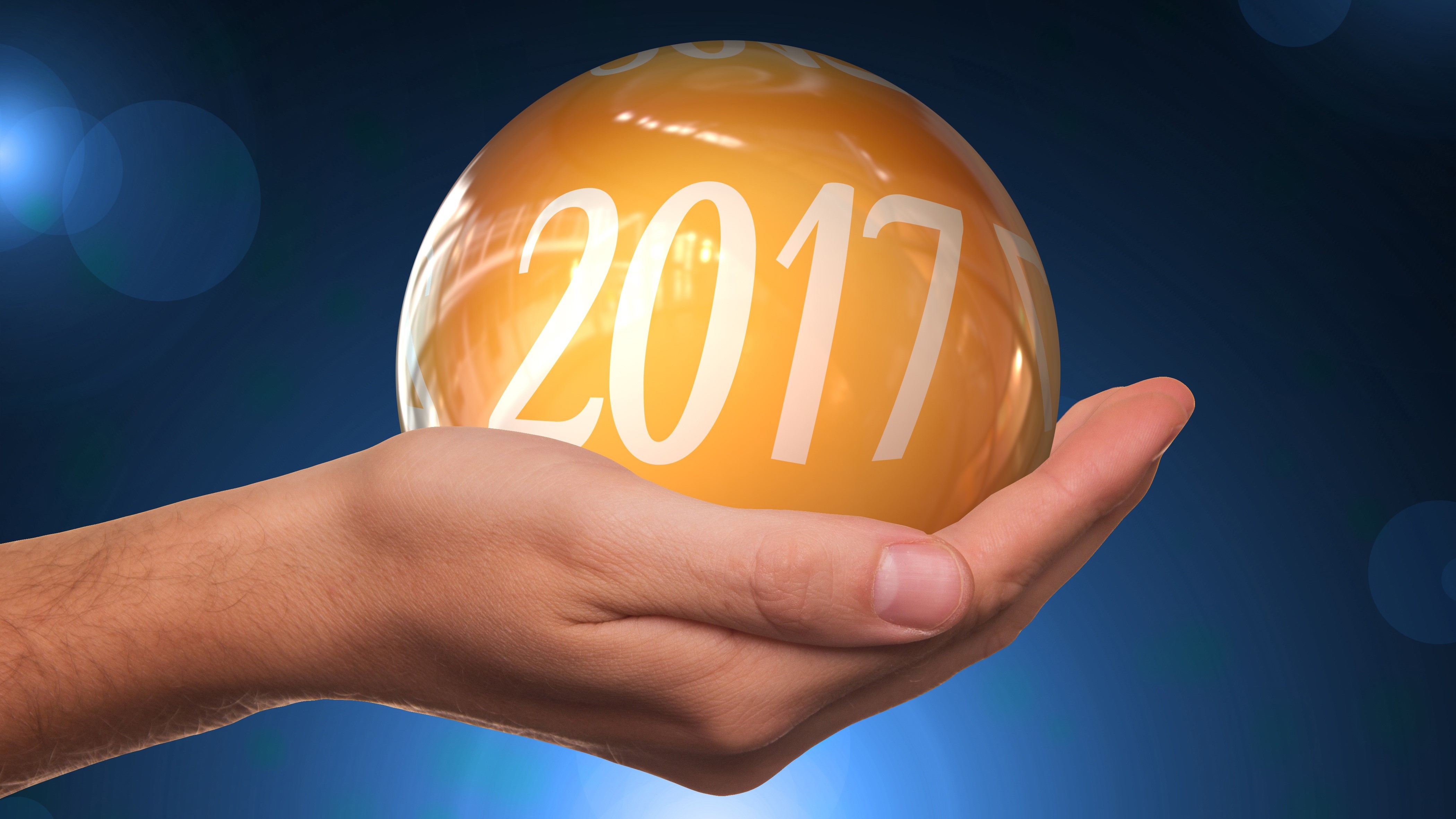 Hand holding a 2017 New Year's ball HD Wallpaper