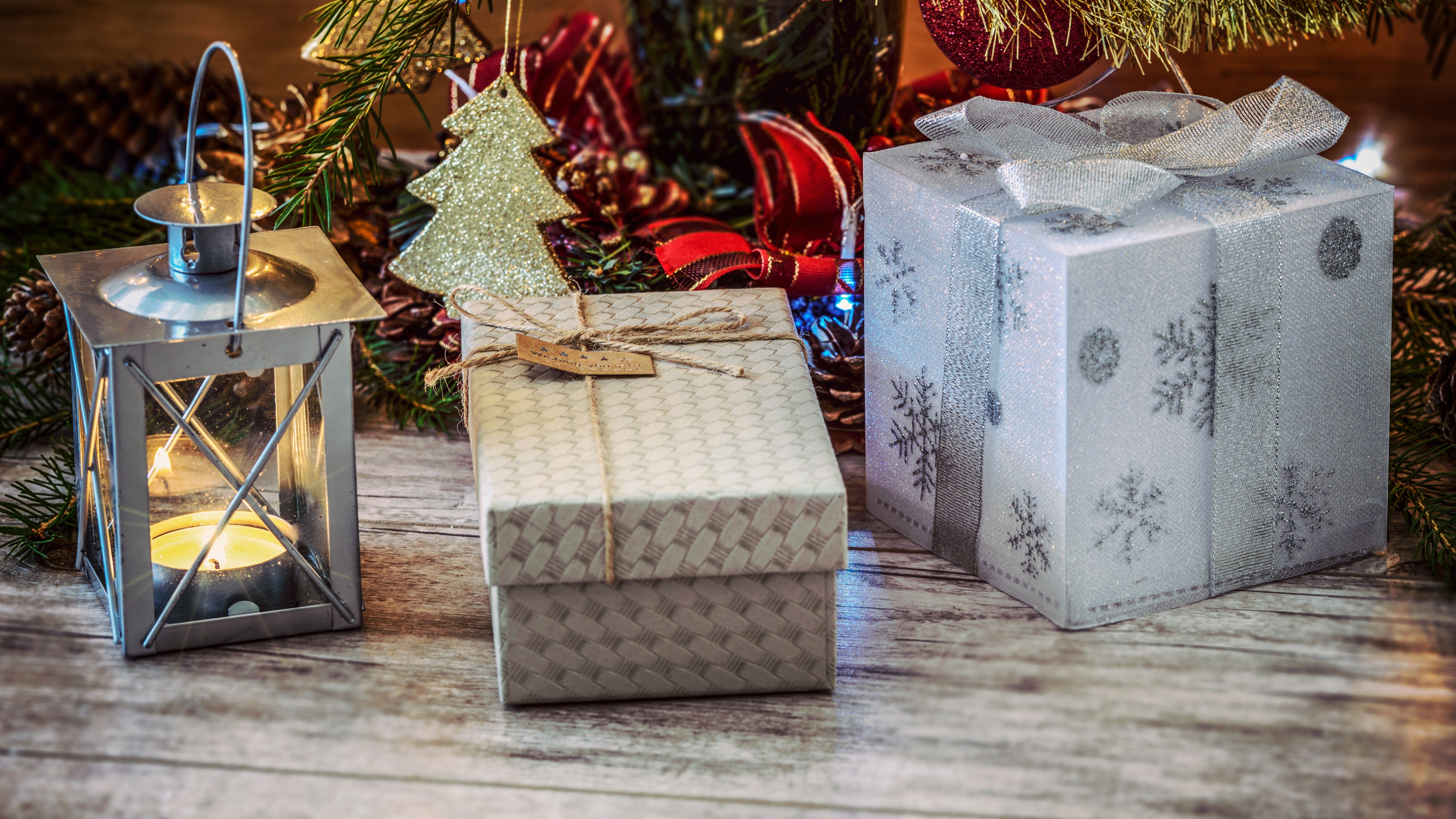 Christmas gifts and lantern under a tree HD Wallpaper