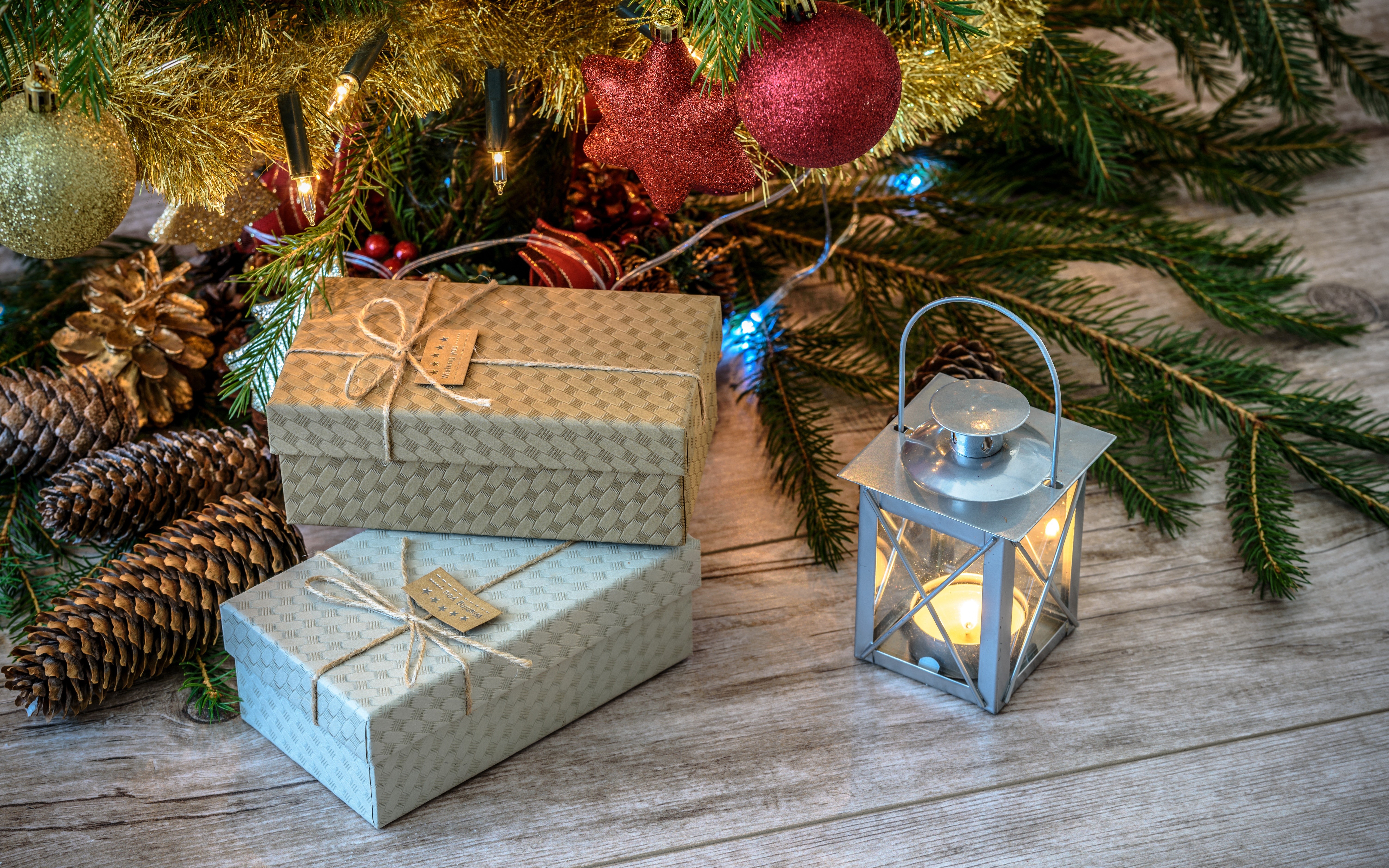 Christmas gifts and lantern under a tree HD Wallpaper