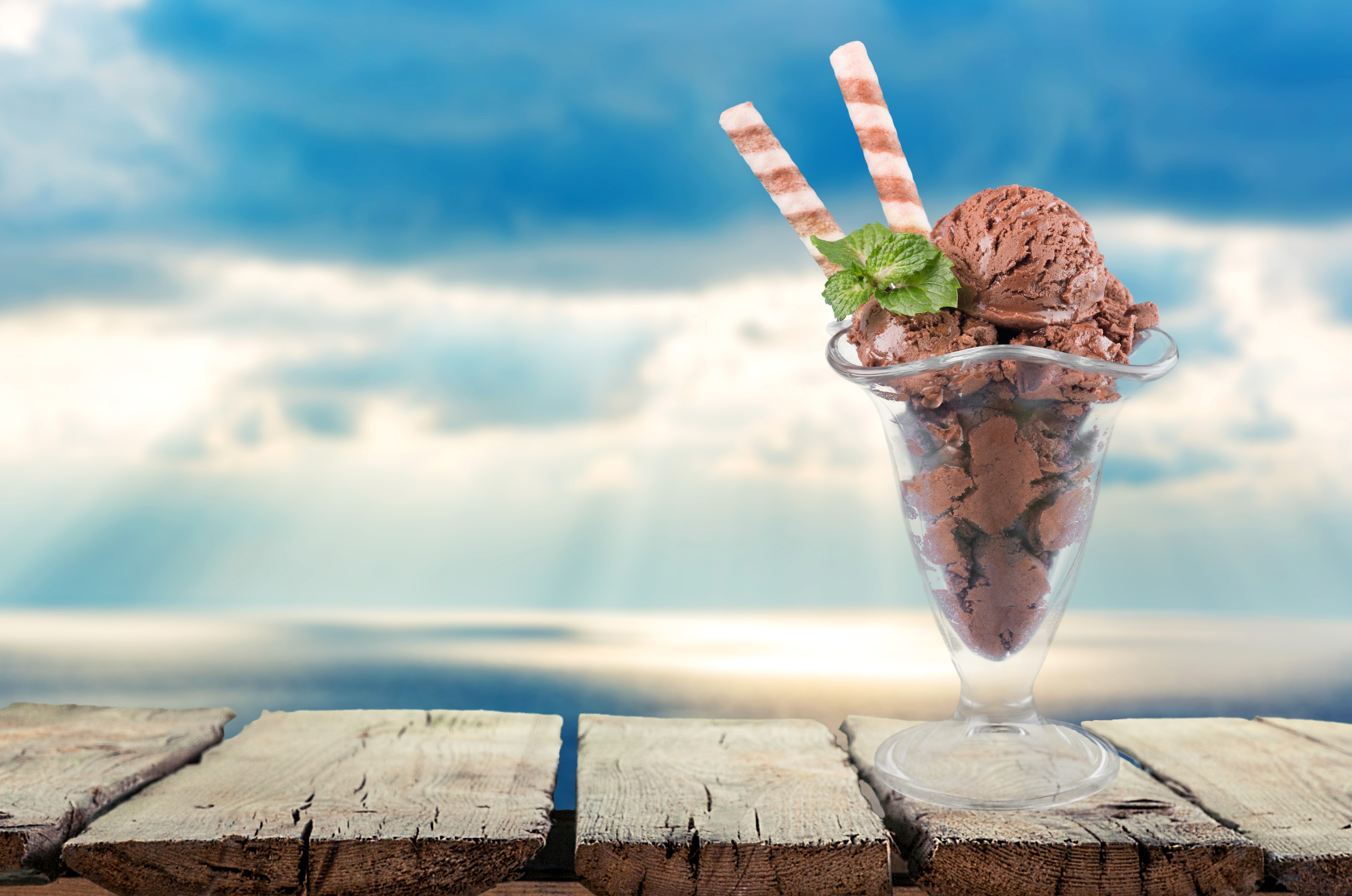 Chocolate ice cream sundae with wafer sticks on wooden planks HD Wallpaper