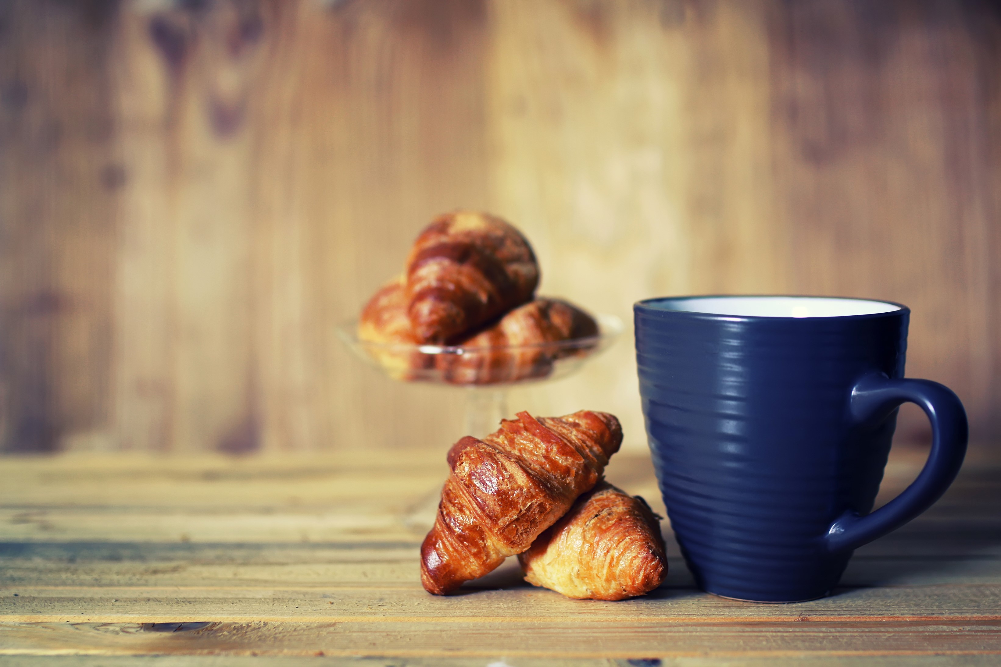 Blue mug with croissants on wooden planks HD Wallpaper