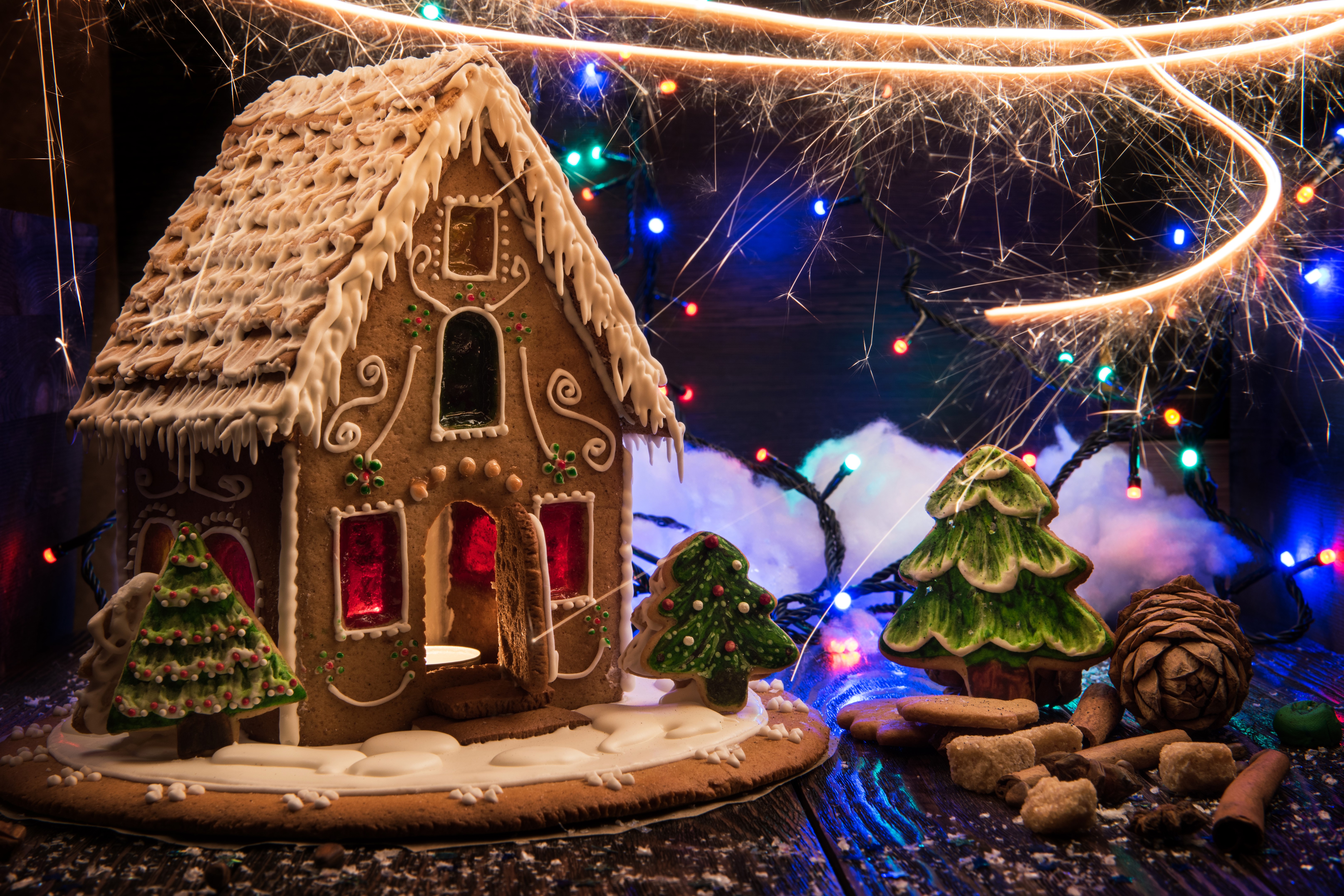 Gingerbread house with Christmas lights and sparklers HD Wallpaper