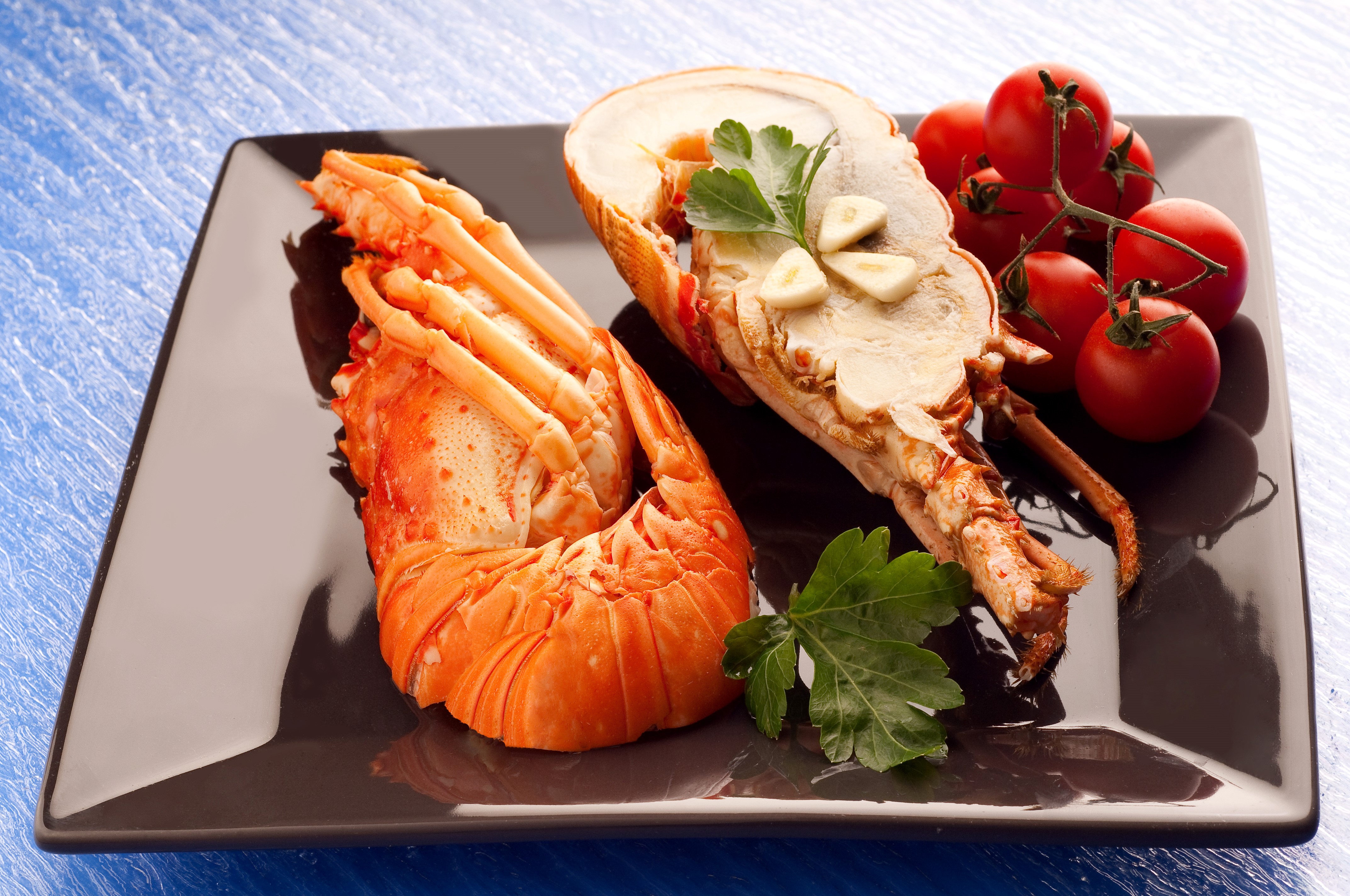 Lobster tail with tomatoes and garlic on a plate HD Wallpaper