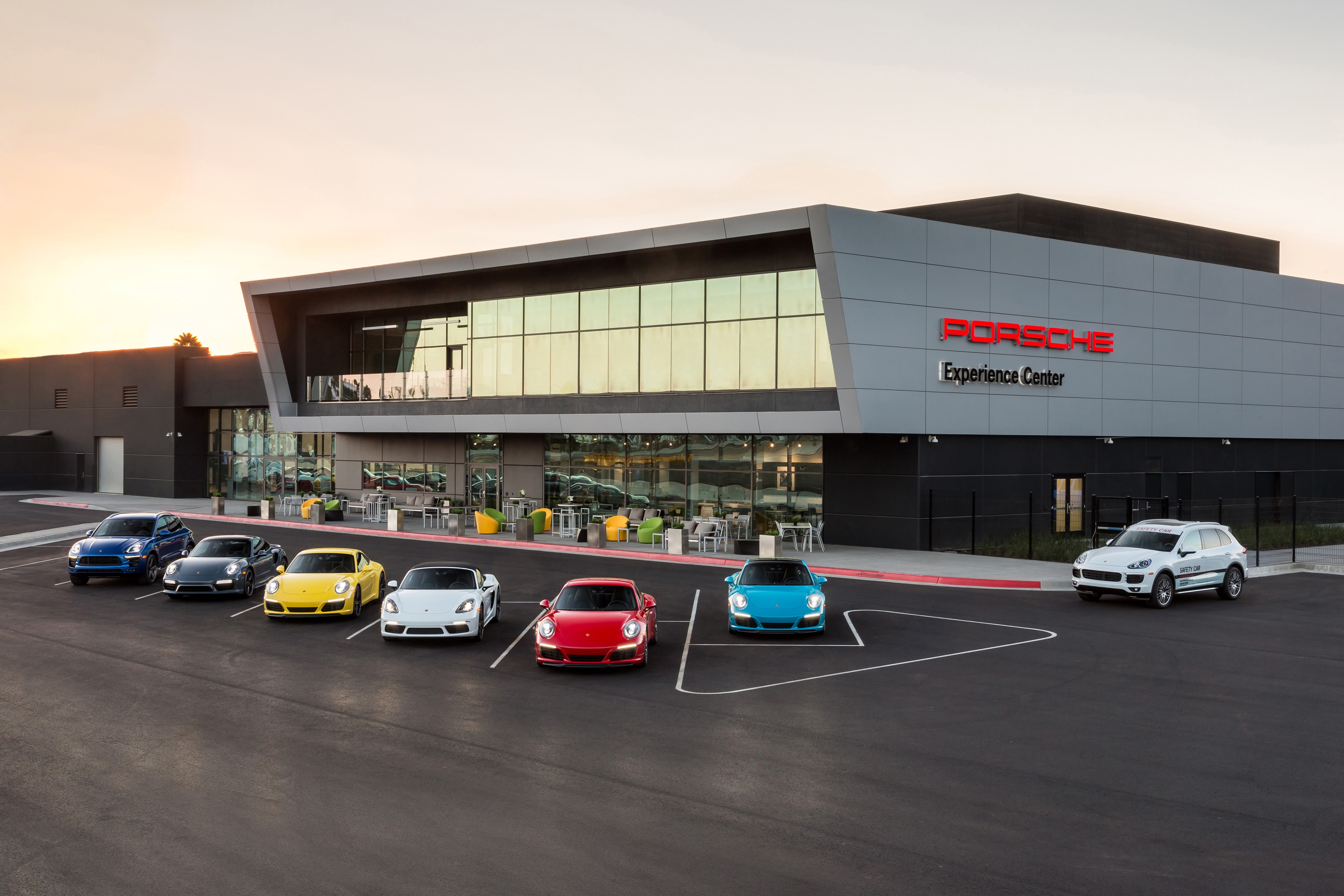 Porsche Experience Center with multiple cars parked HD Wallpaper