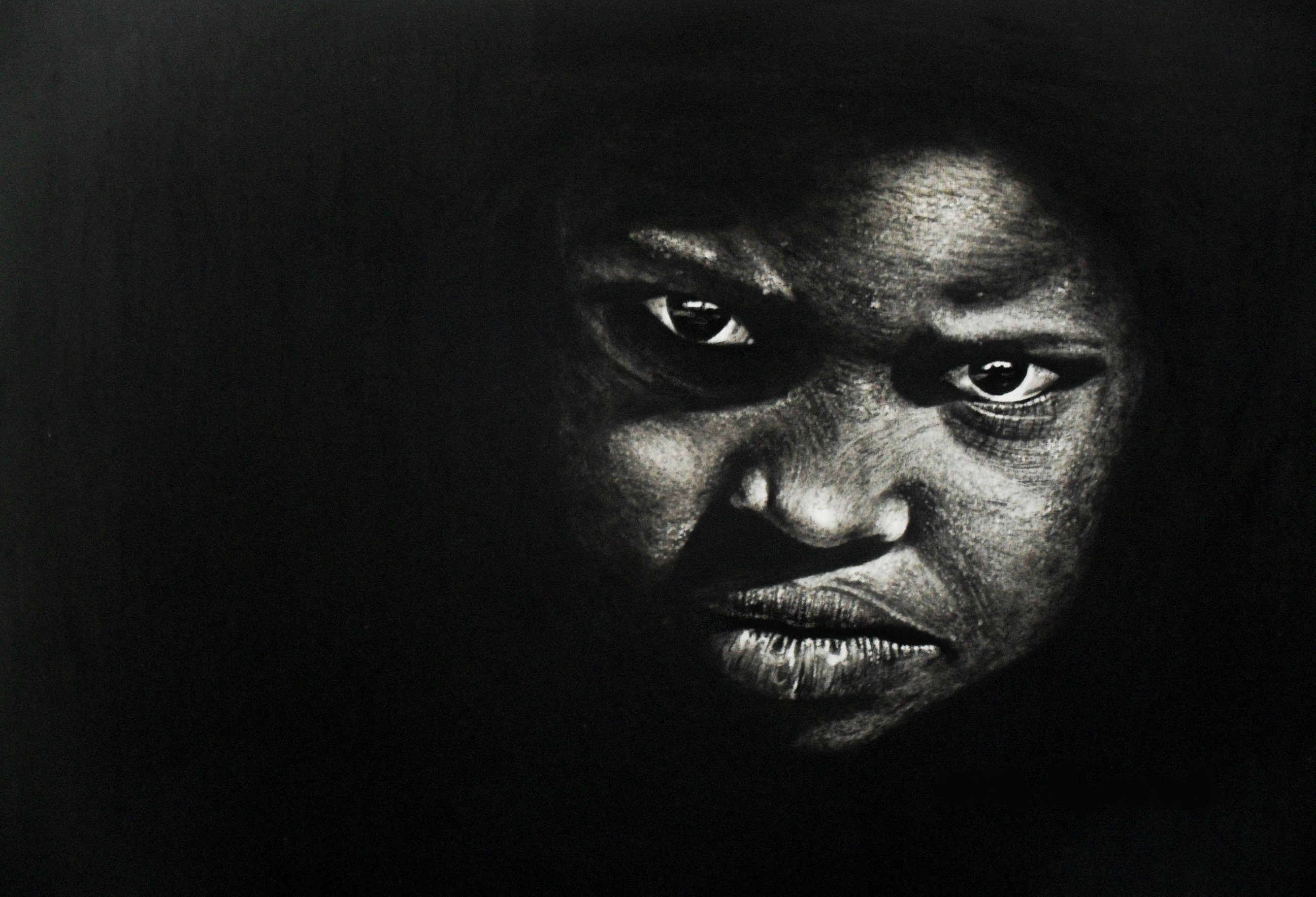 Close-up of a young Black person's face in shadow HD Wallpaper