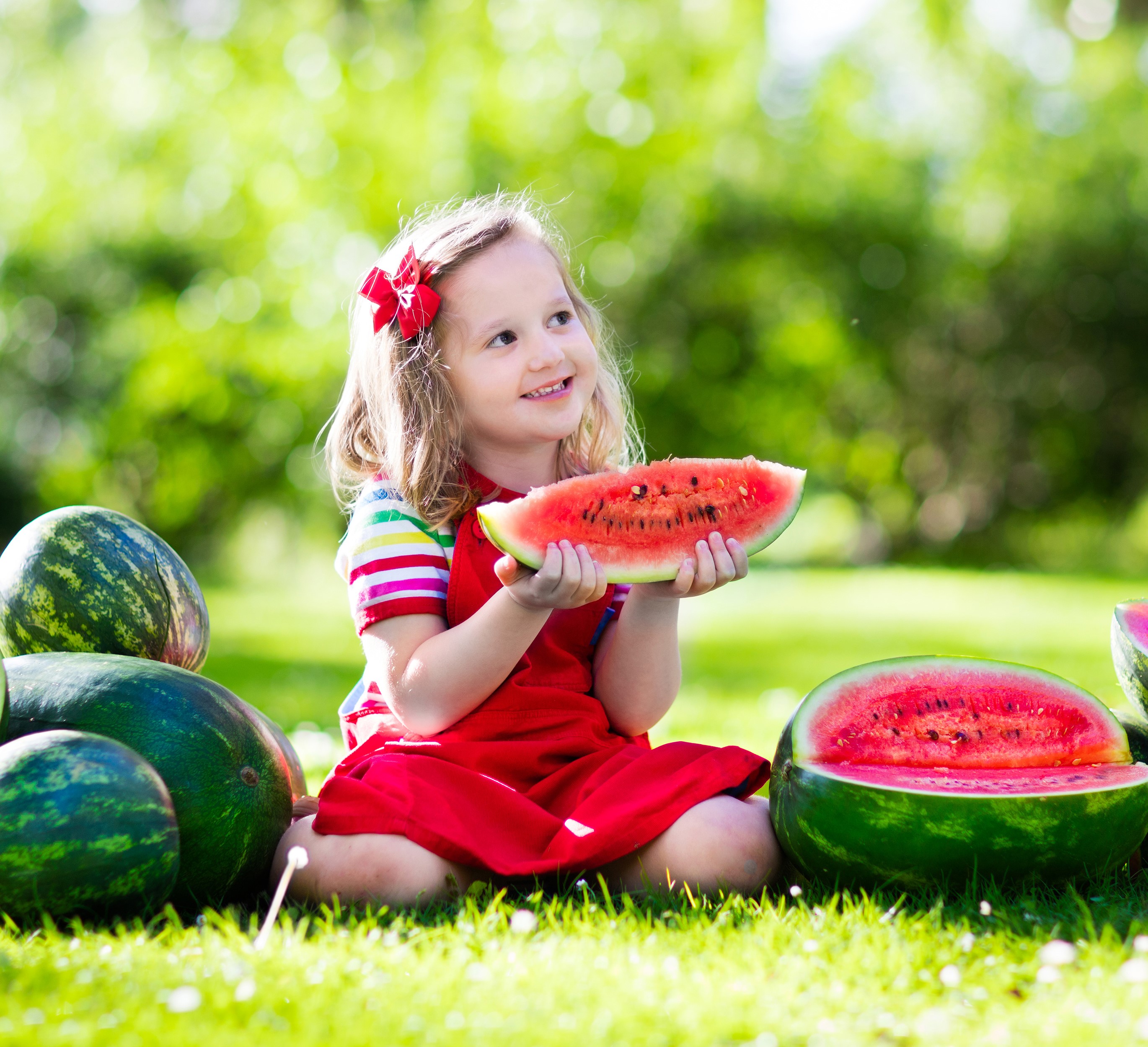 Girl eating watermelon in grass HD Wallpaper