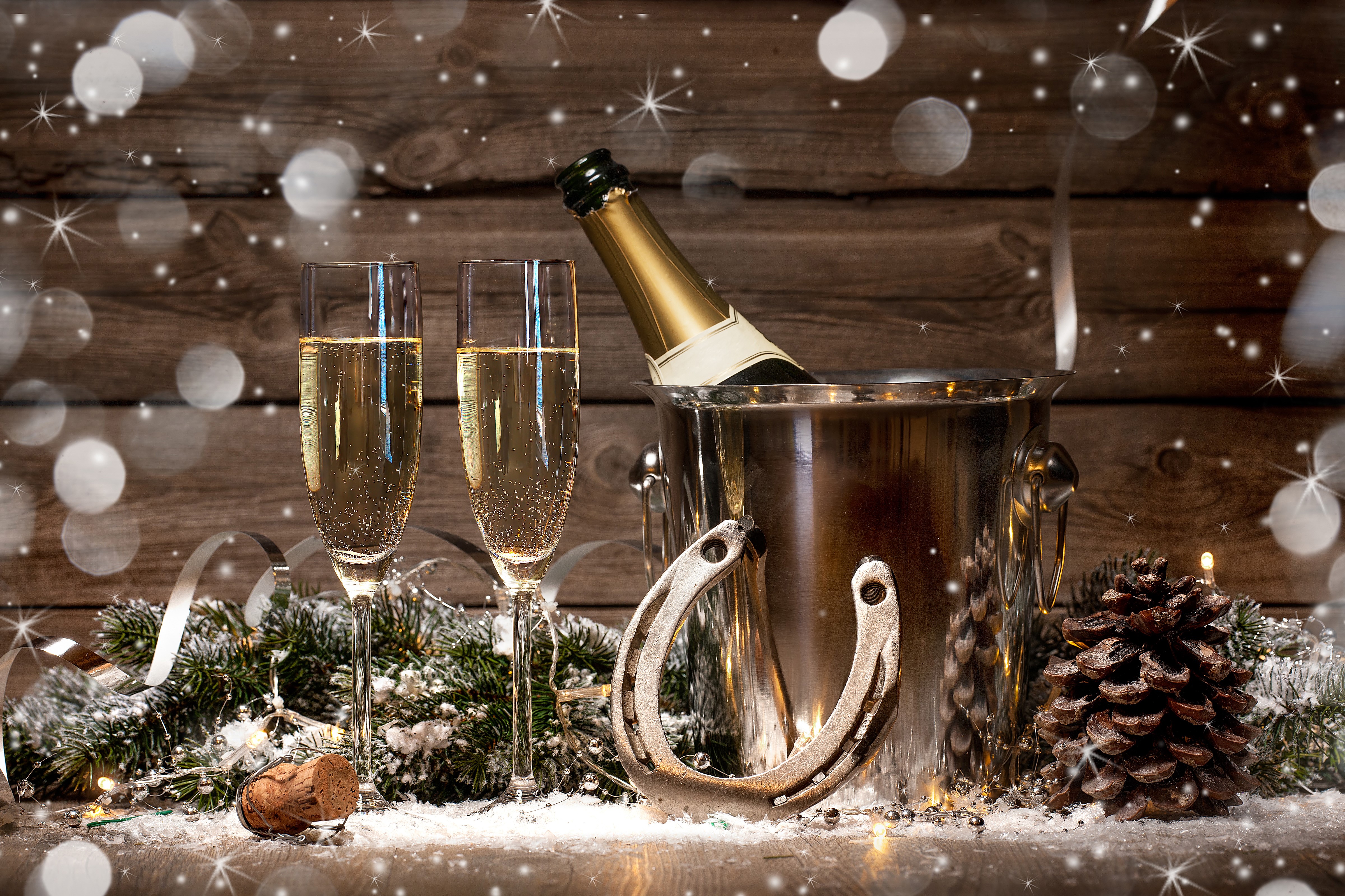 Champagne bottle and glasses with pine cone and snow HD Wallpaper