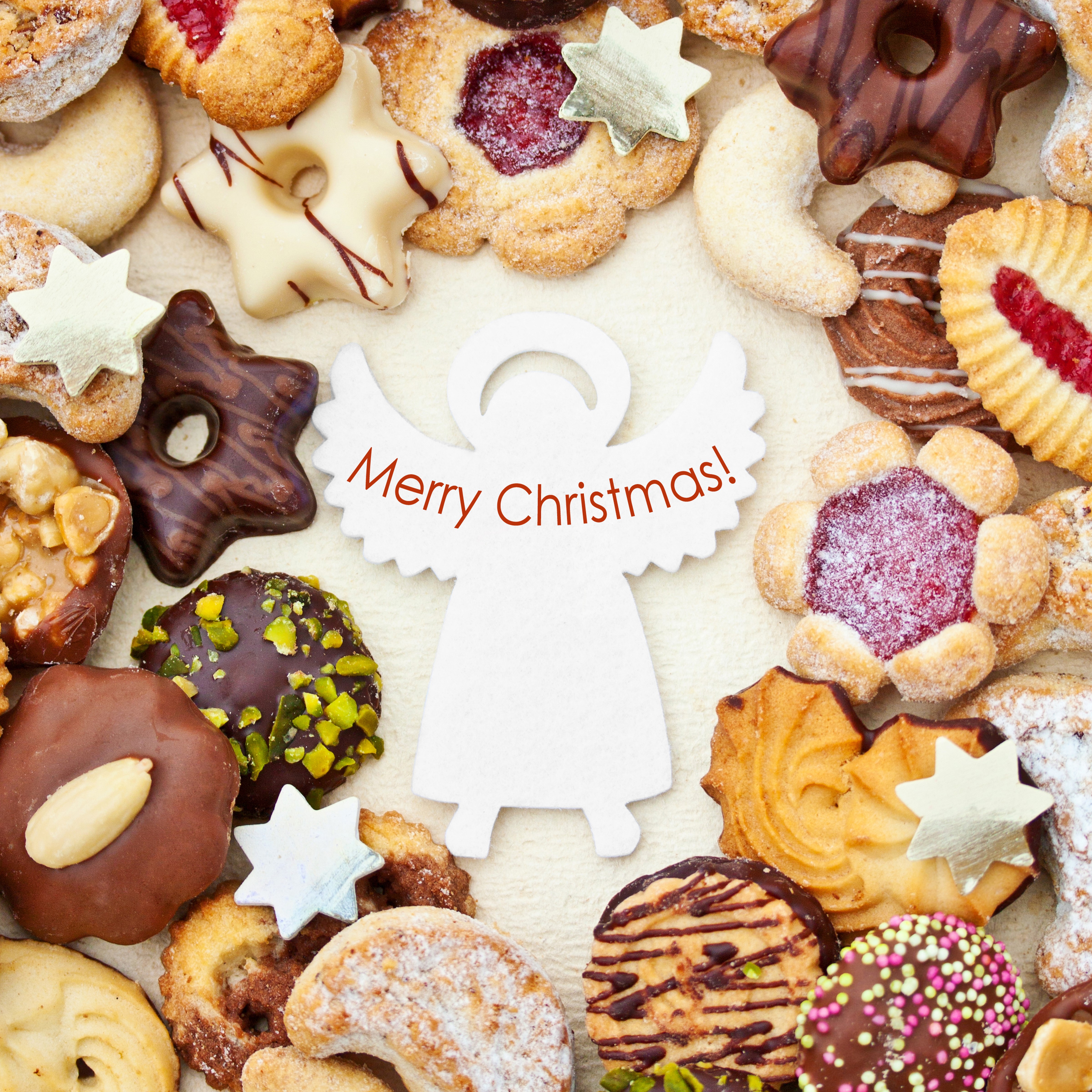 Christmas cookies arranged around a Merry Christmas angel decoration HD Wallpaper