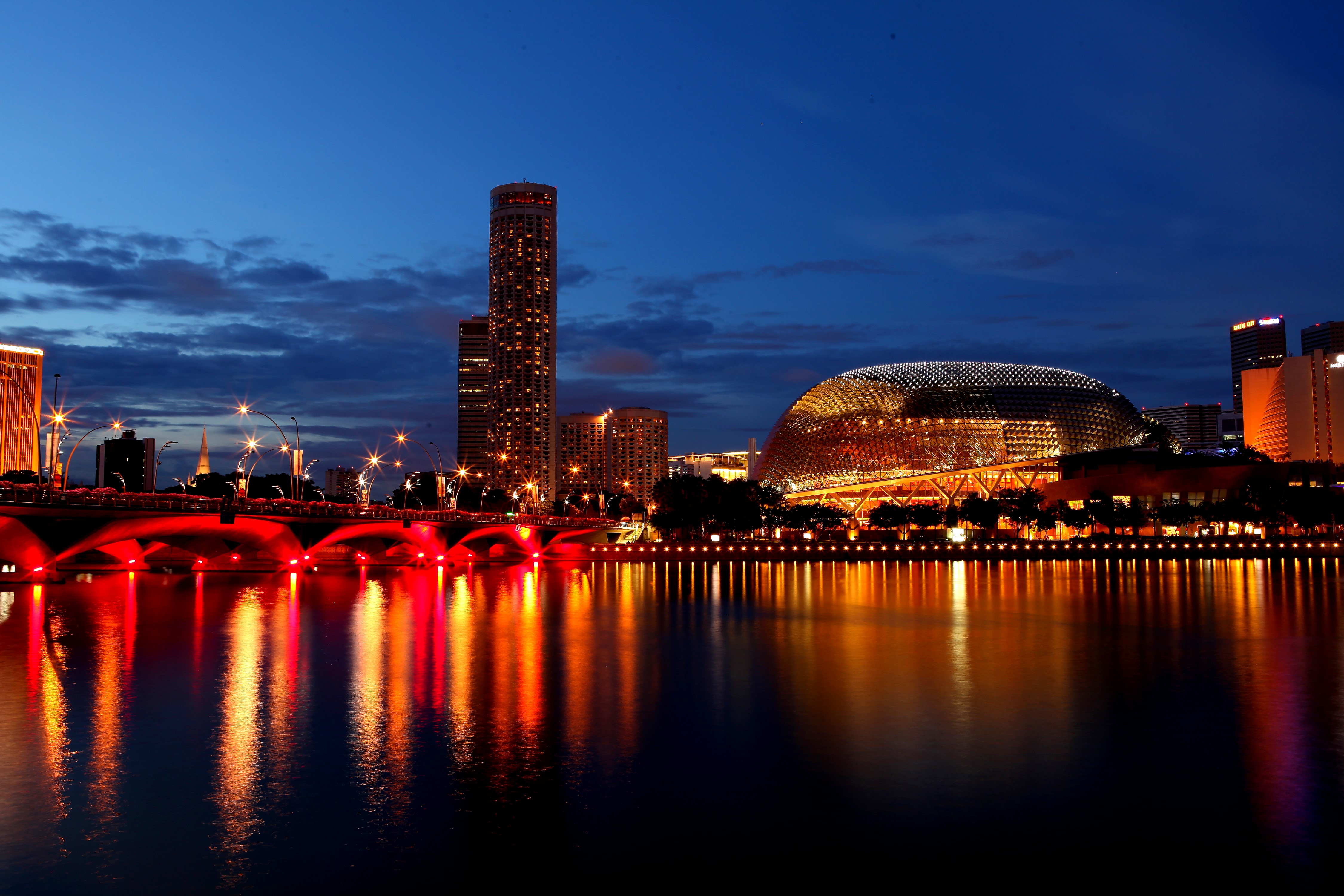 Singapore skyline at night with illuminated bridge and buildings HD Wallpaper