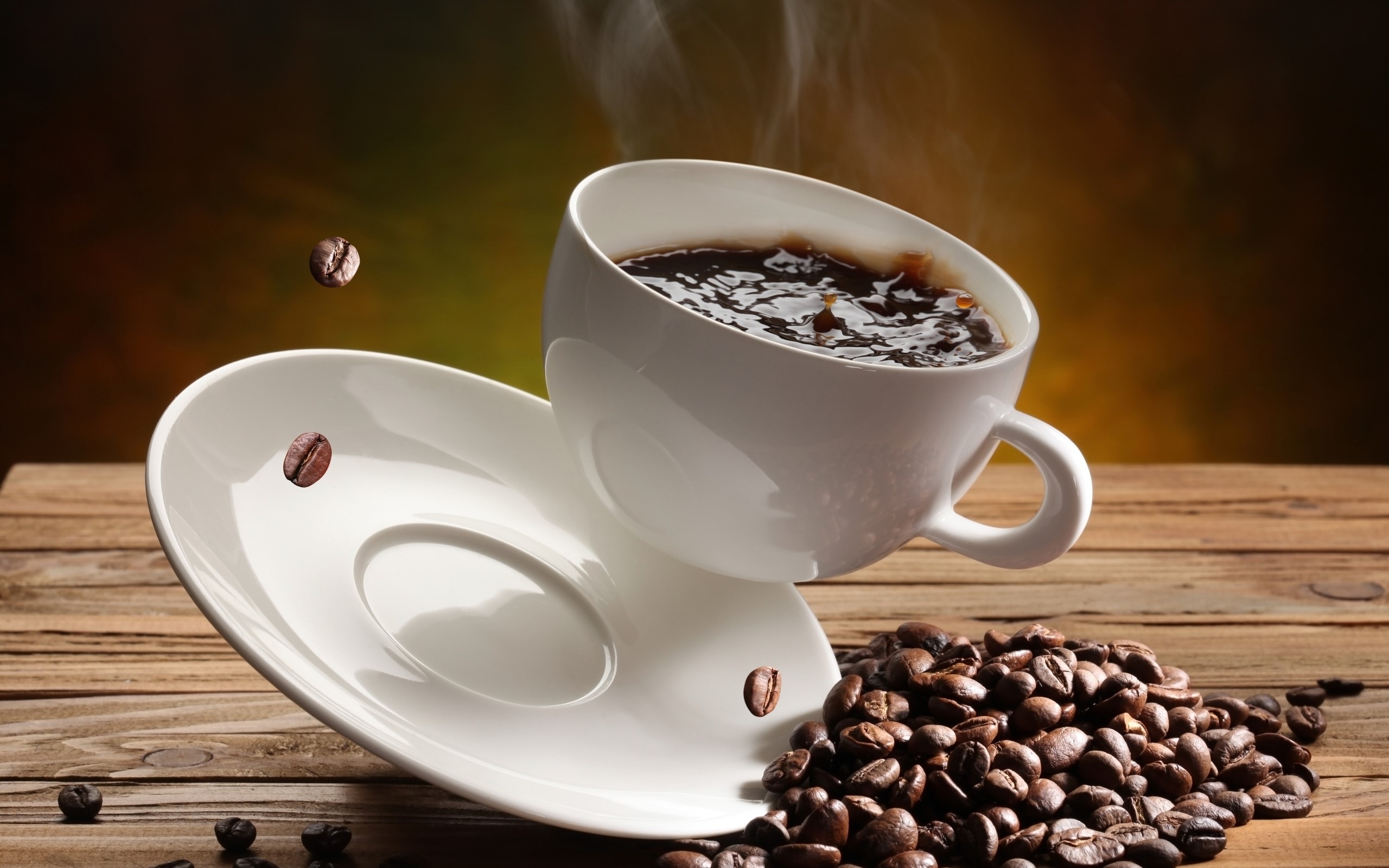 Steaming cup of coffee with beans and saucer HD Wallpaper