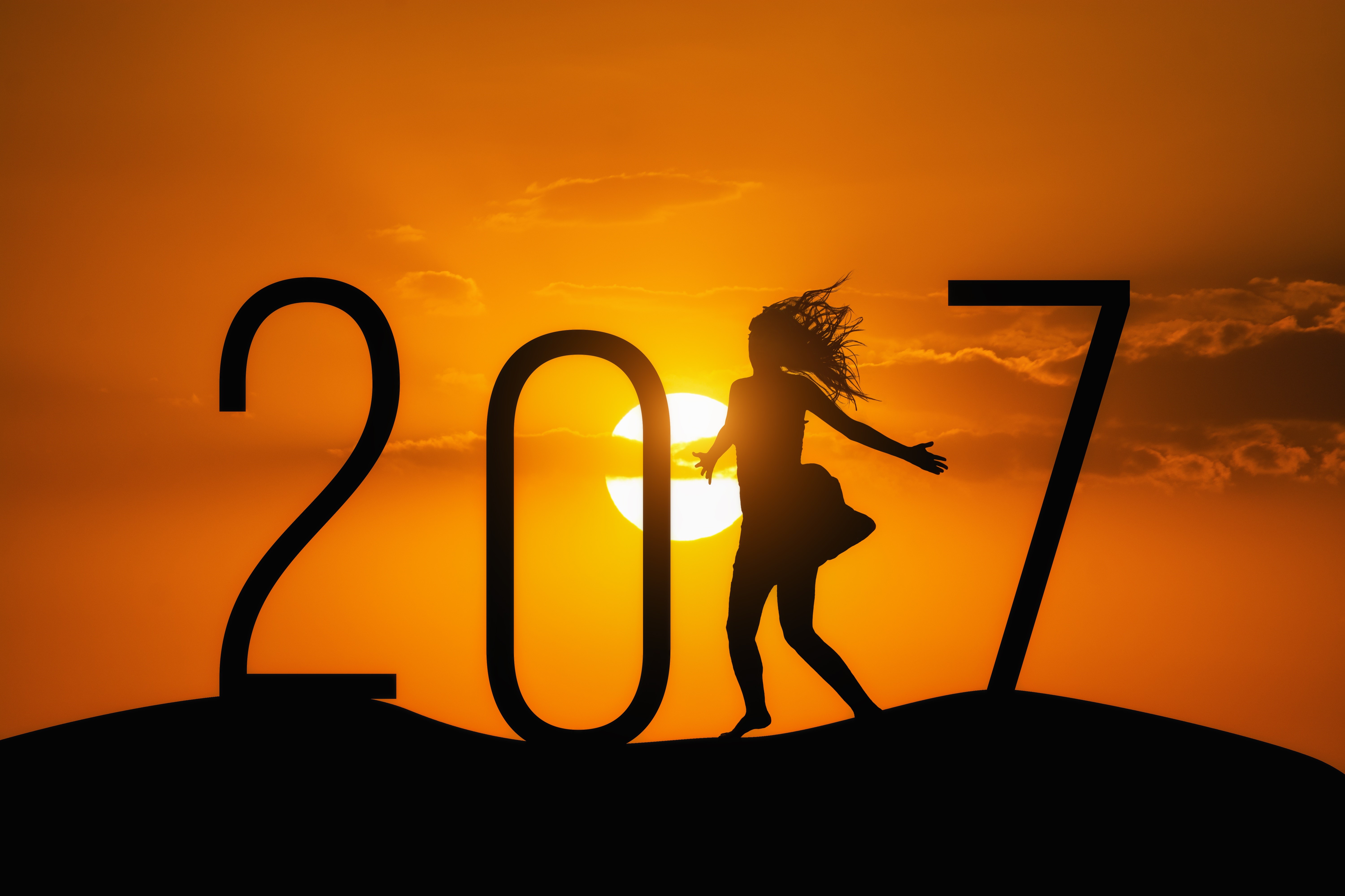 Silhouette of a woman dancing in front of the sun with the year 2017 HD Wallpaper