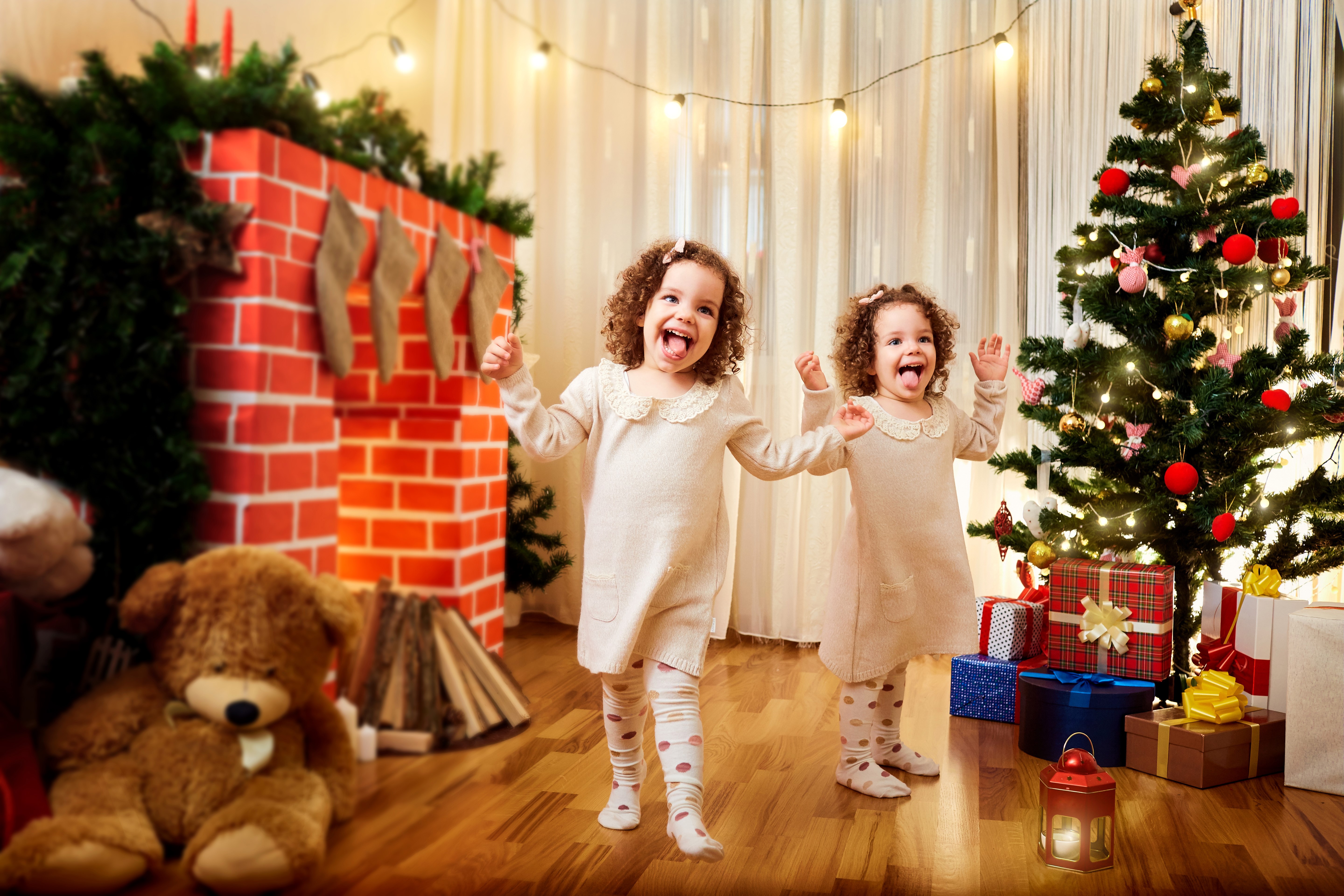Two girls by Christmas tree and fireplace HD Wallpaper