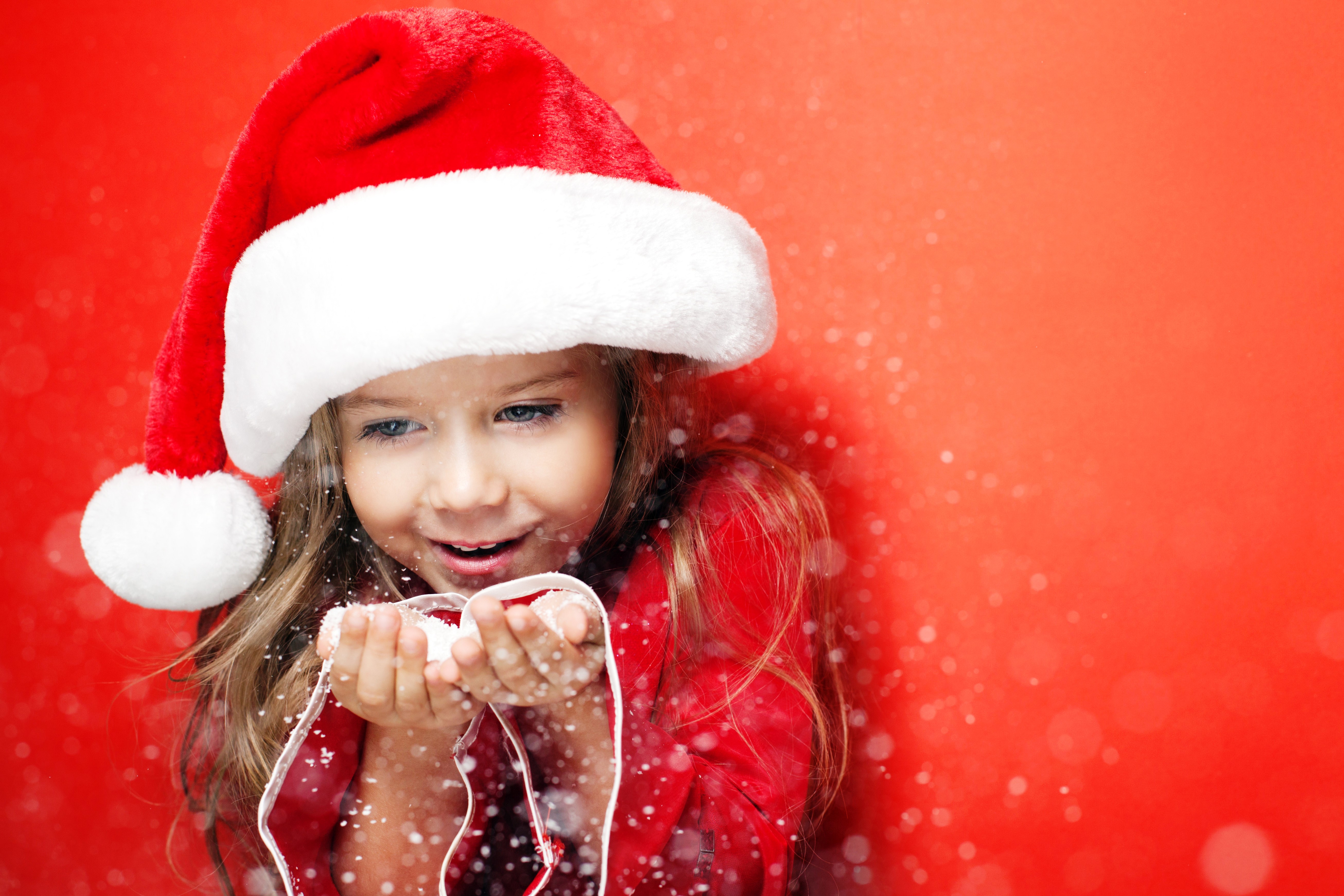 Little girl in Santa hat blowing snow HD Wallpaper