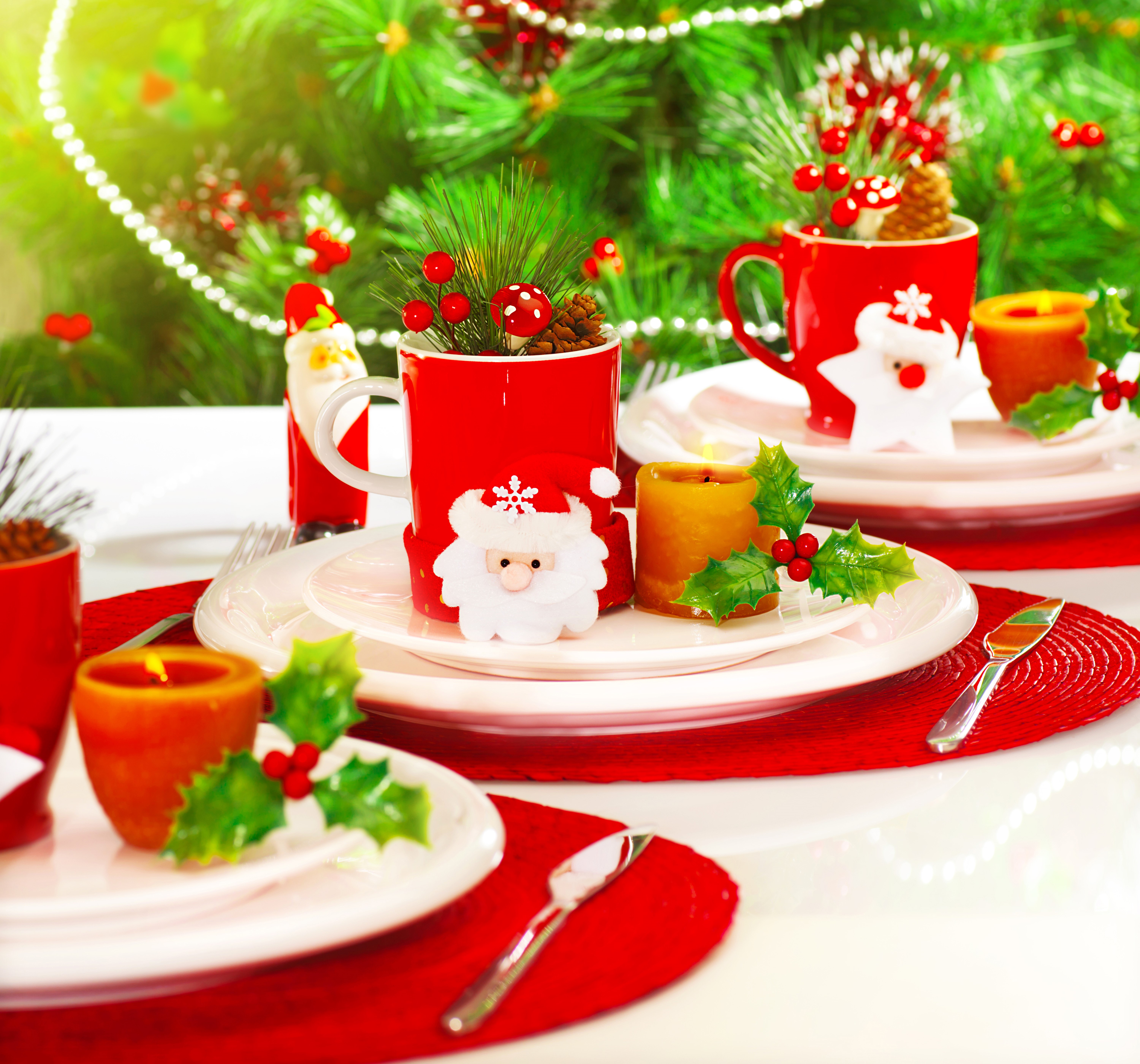 Christmas table setting with Santa Claus mugs and candles HD Wallpaper