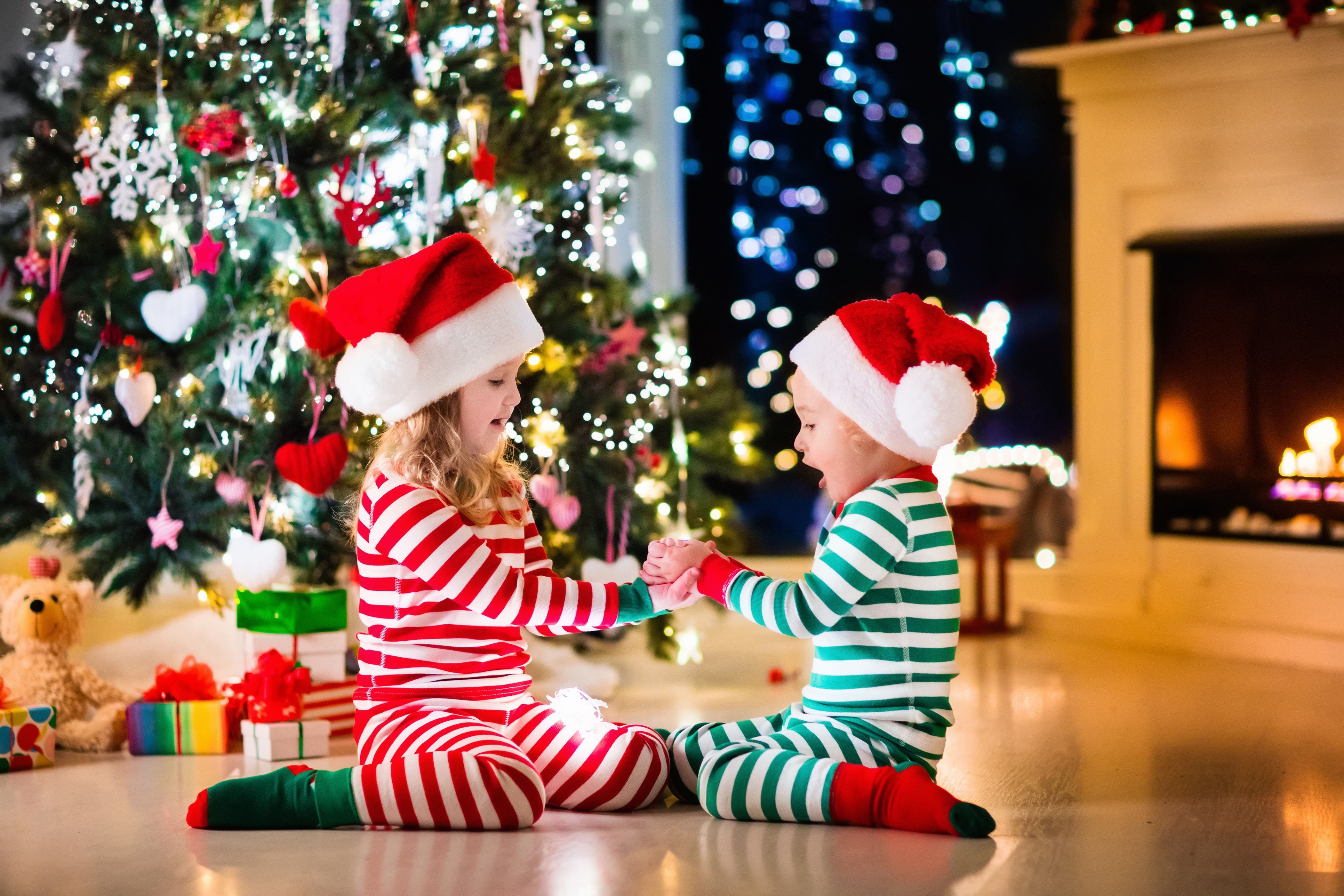 Two Children in Pajamas by Christmas Tree HD Wallpaper