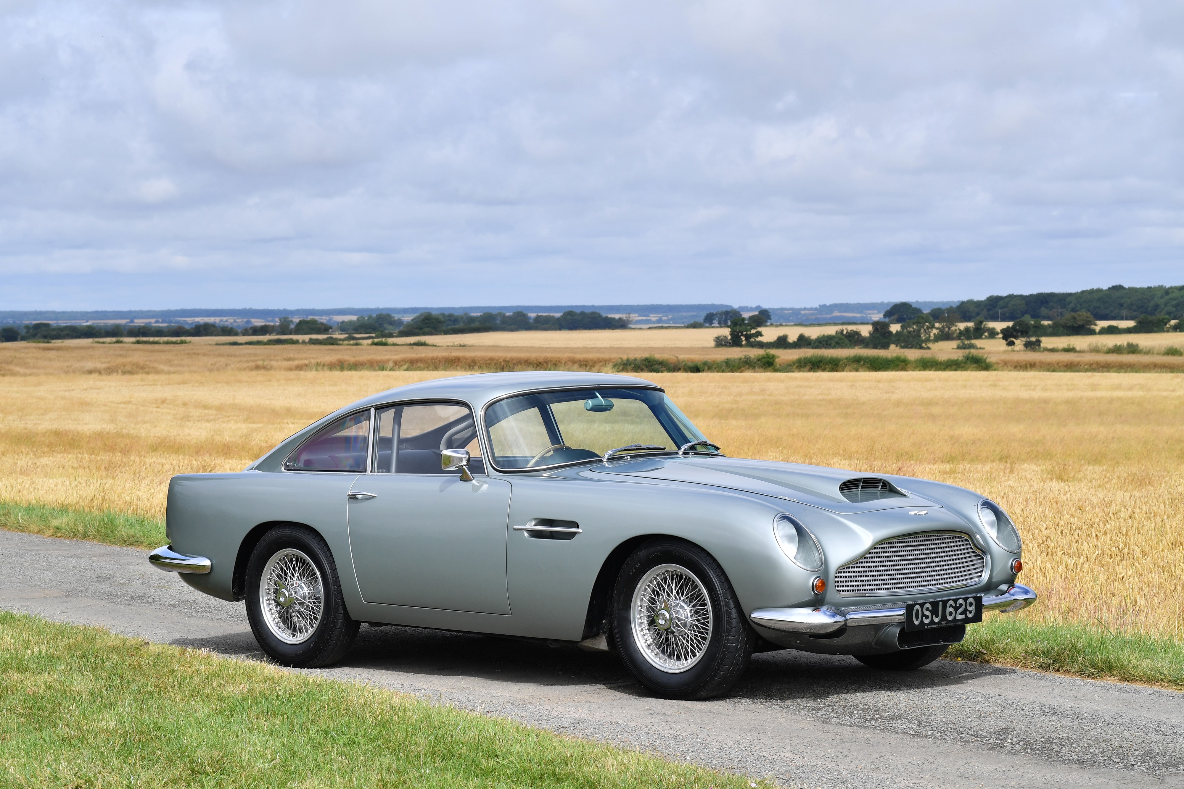 Grey Aston Martin DB4 GT Touring on a road HD Wallpaper