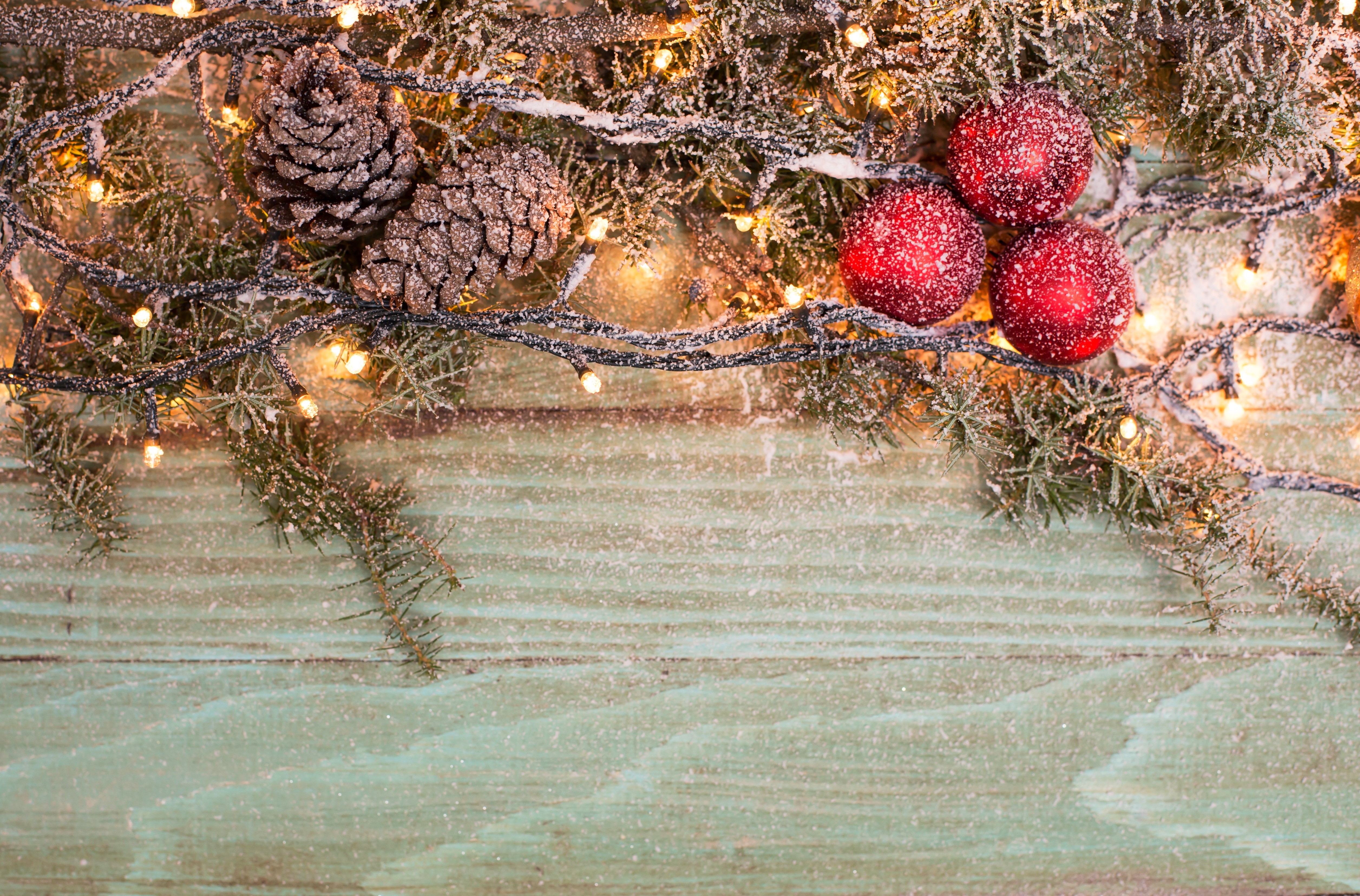 Christmas pine cones, ornaments, and fairy lights on wood HD Wallpaper