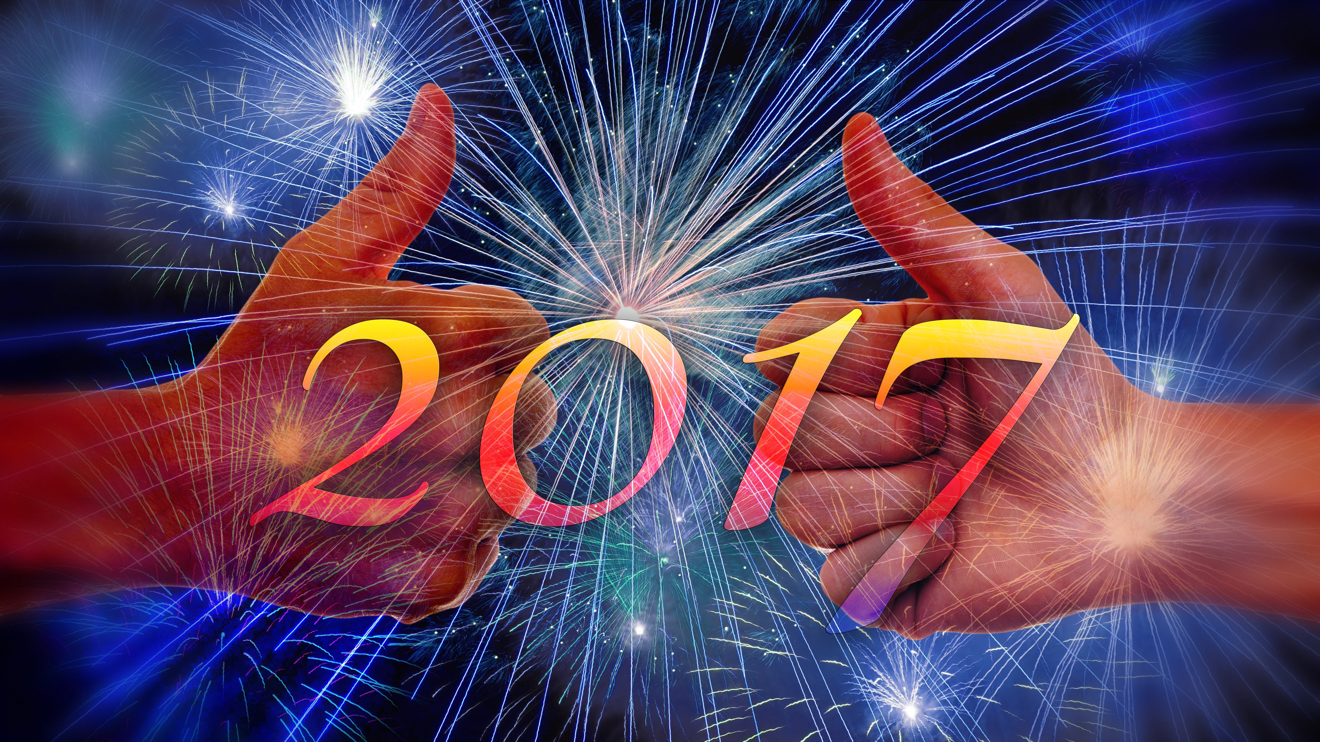 Two hands giving thumbs up with 2017 and fireworks HD Wallpaper